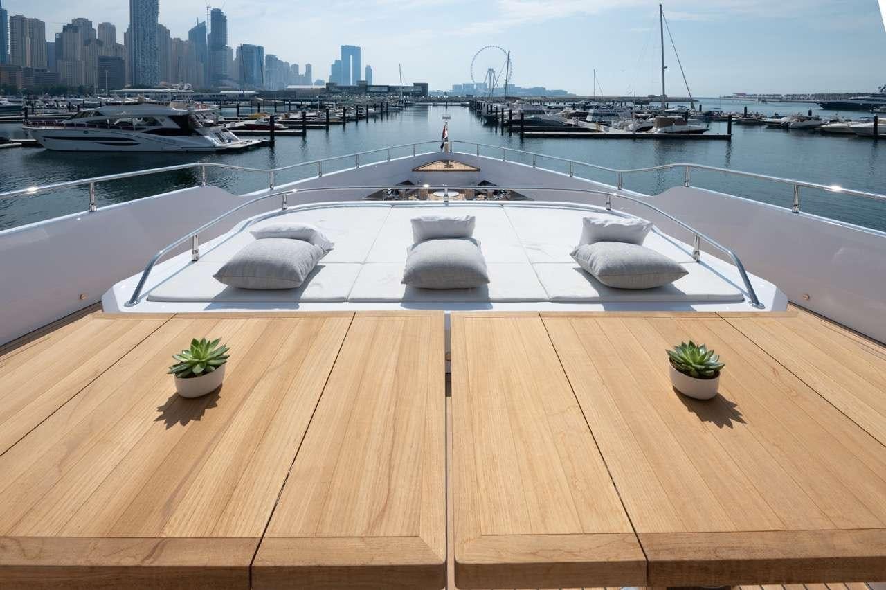 a large pool with a city in the background aboard OLIVIA Yacht for Charter