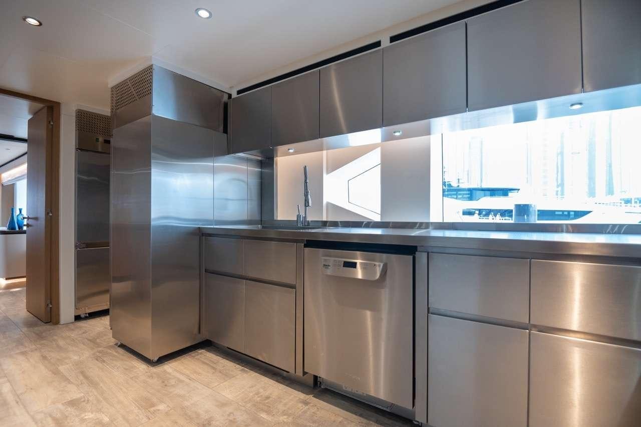 a kitchen with a large refrigerator aboard OLIVIA Yacht for Charter