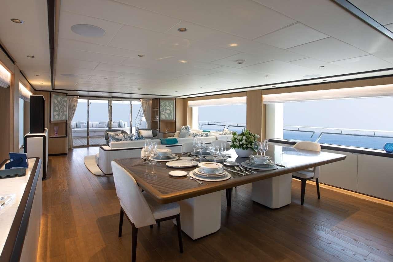 a large dining table with plates and chairs aboard OLIVIA Yacht for Charter