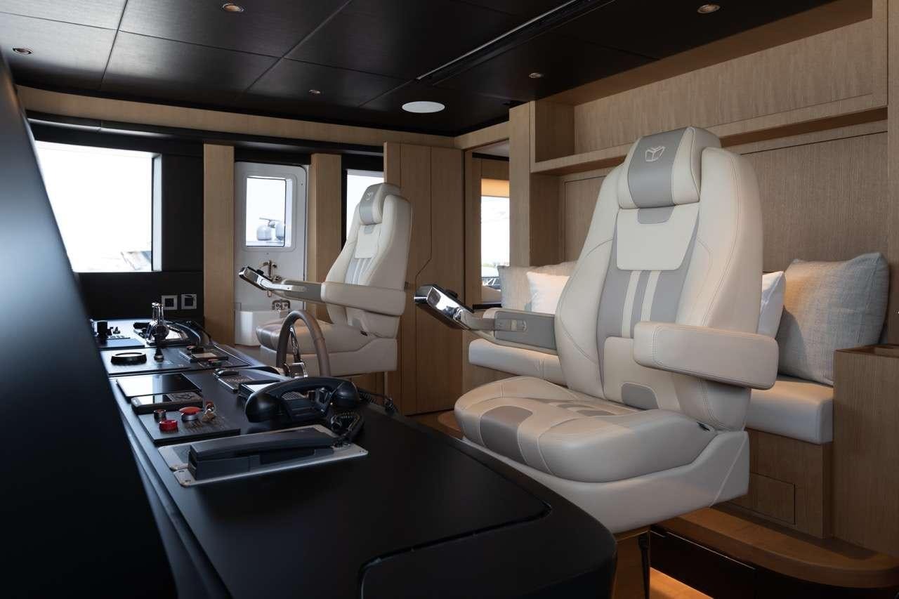 a room with a desk and chairs aboard OLIVIA Yacht for Charter