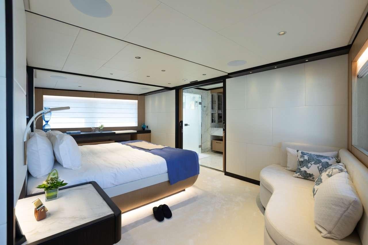 a bedroom with a bed and a table aboard OLIVIA Yacht for Charter