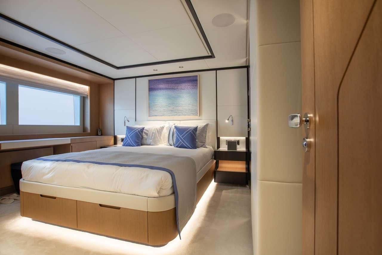 a room with a bed and a desk aboard OLIVIA Yacht for Charter
