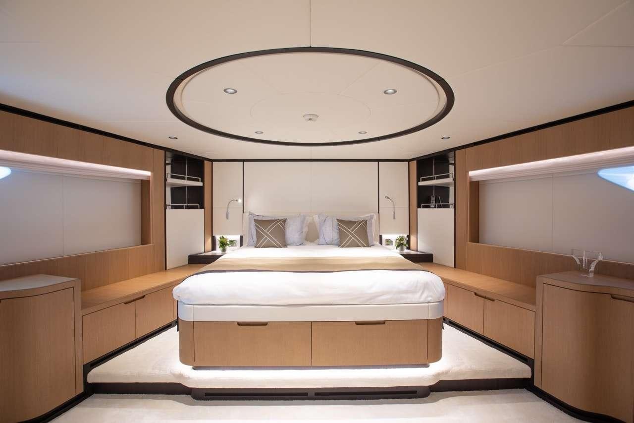 a modern bedroom with a large mirror aboard OLIVIA Yacht for Charter