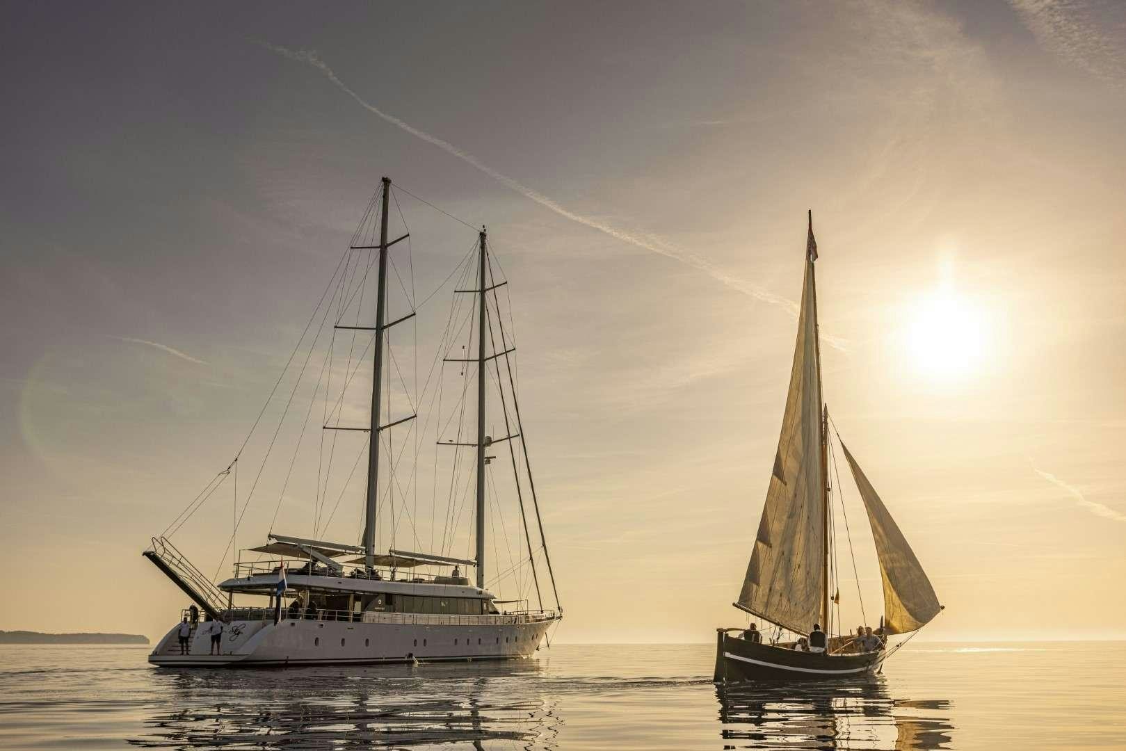 a couple of sailboats on the water aboard M/S AURUM SKY Yacht for Charter