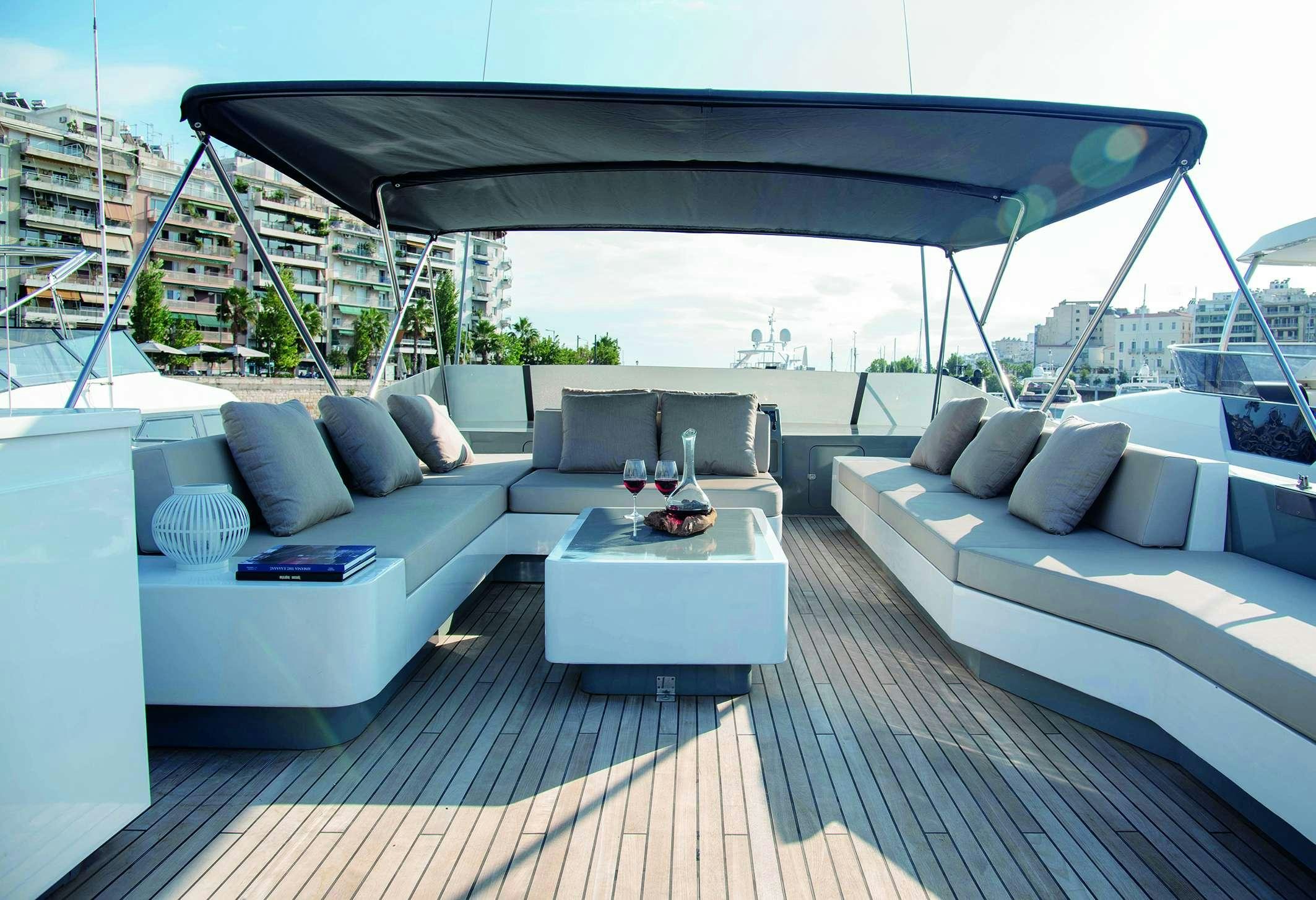 a patio with a couch and a table on it aboard KISS Yacht for Charter