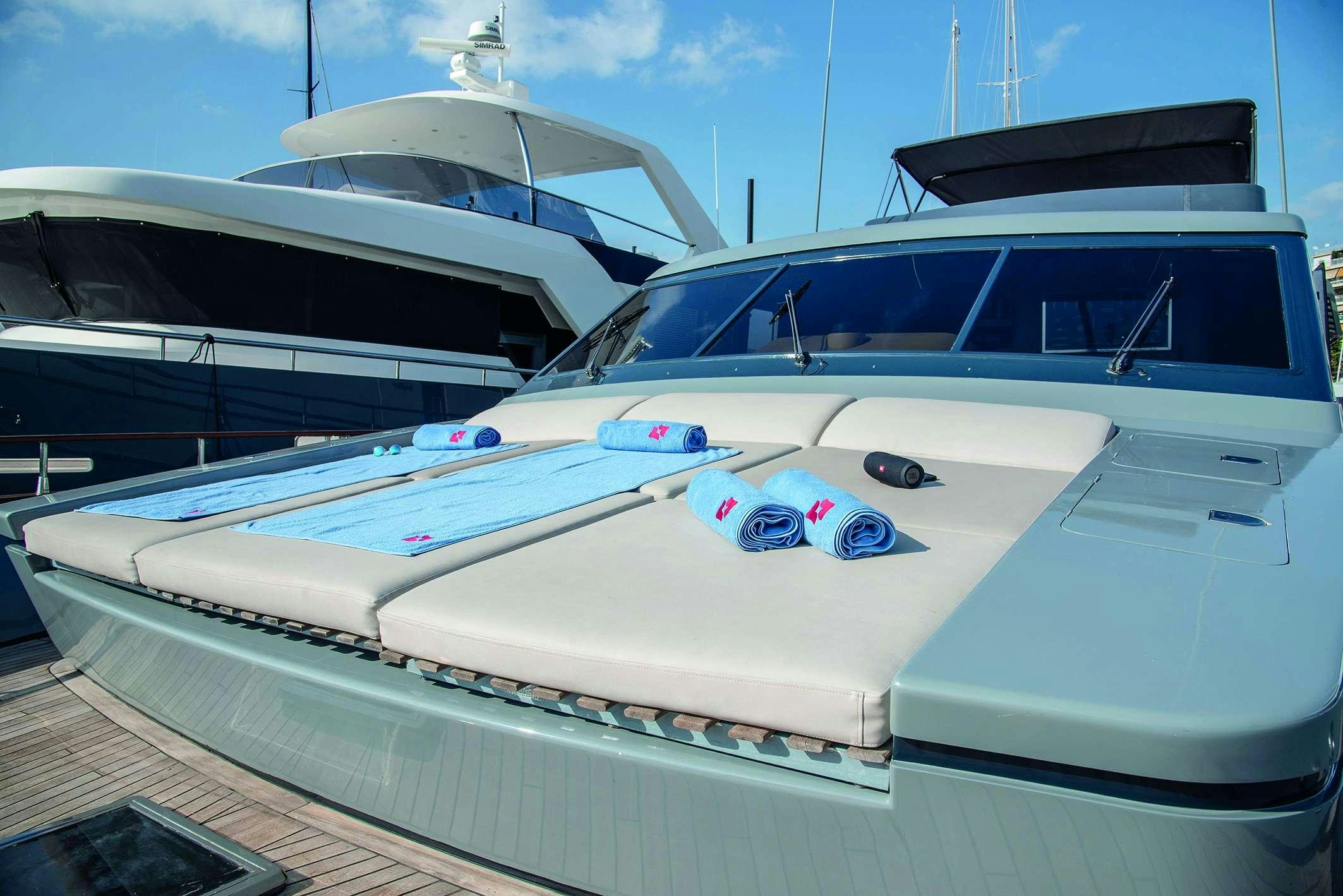 a white boat with blue and red paint aboard KISS Yacht for Charter