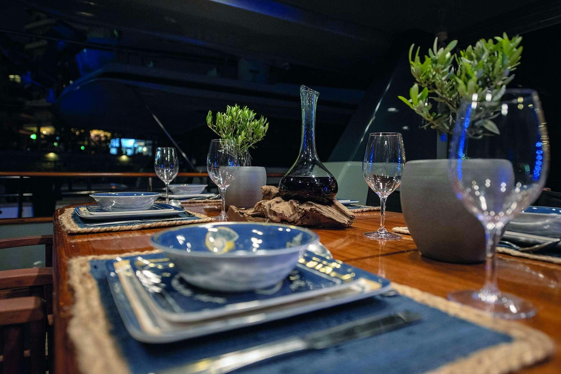 a table with a bowl of food and glasses on it aboard KISS Yacht for Charter