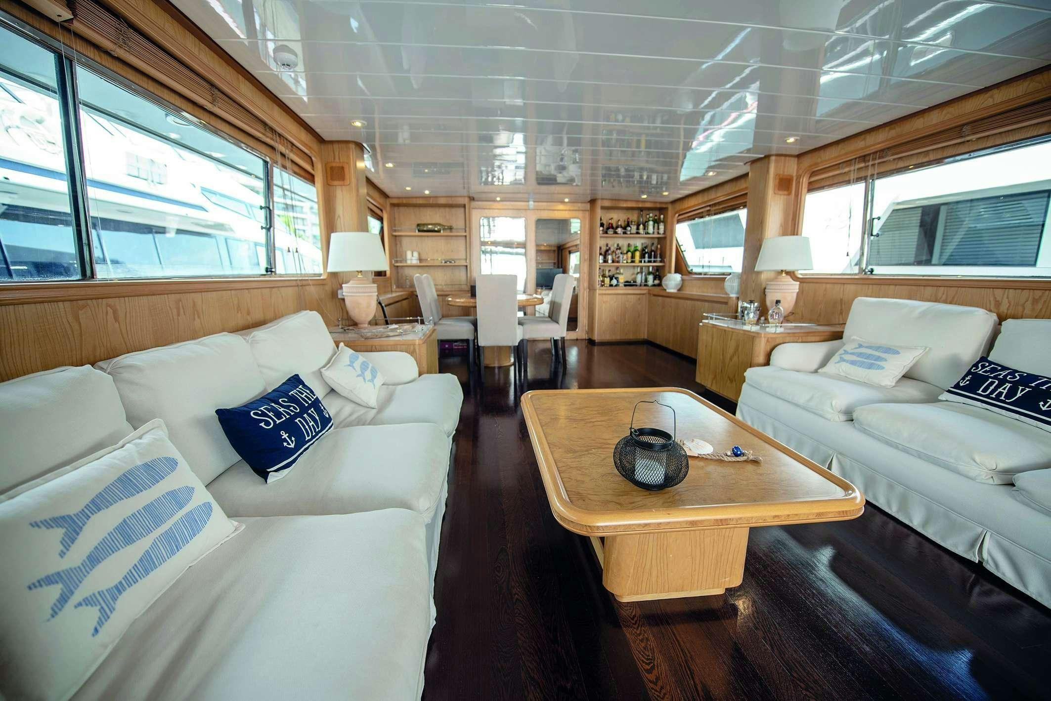 a living room with a couch and a coffee table aboard KISS Yacht for Charter