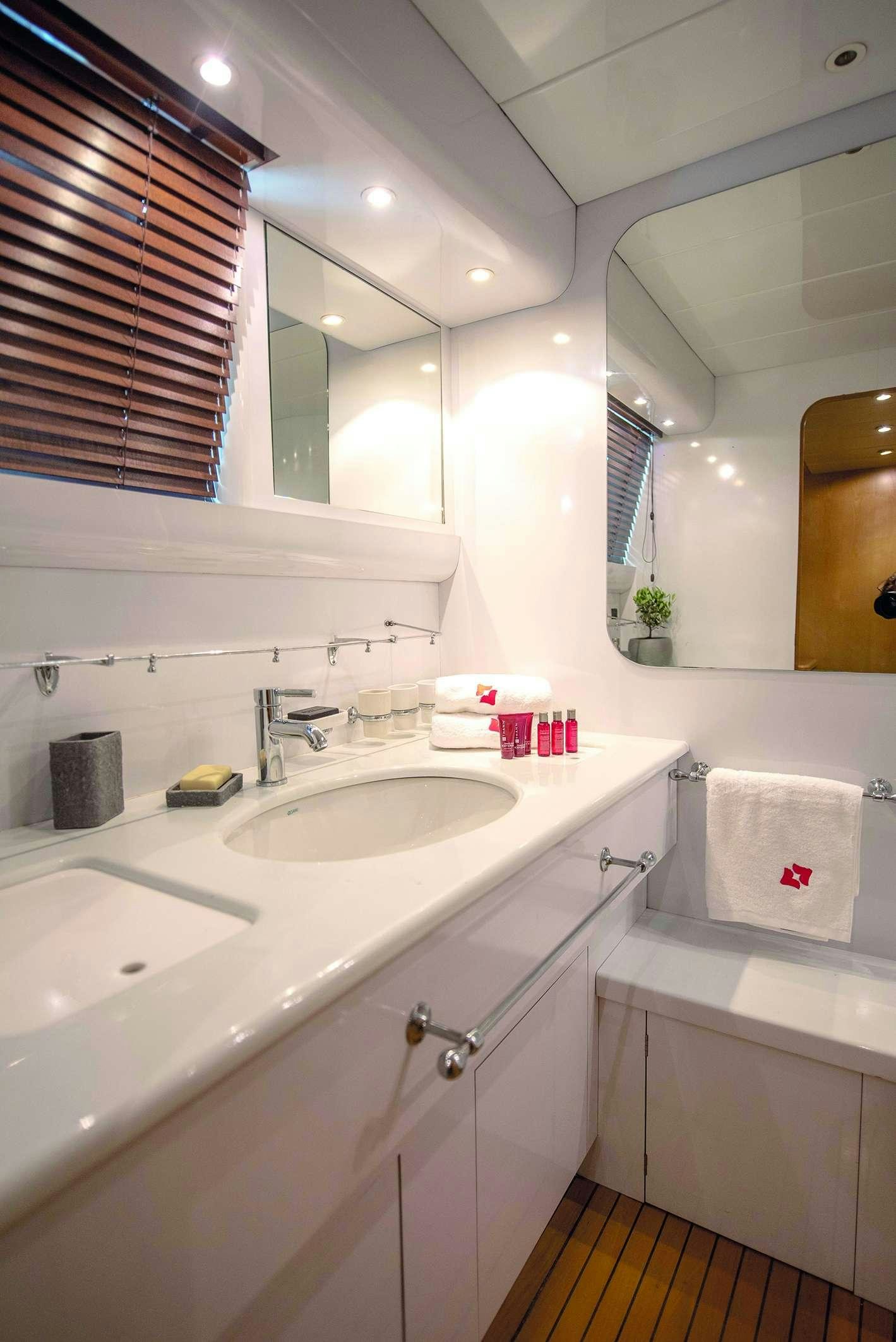 a bathroom with a sink and a mirror aboard KISS Yacht for Charter