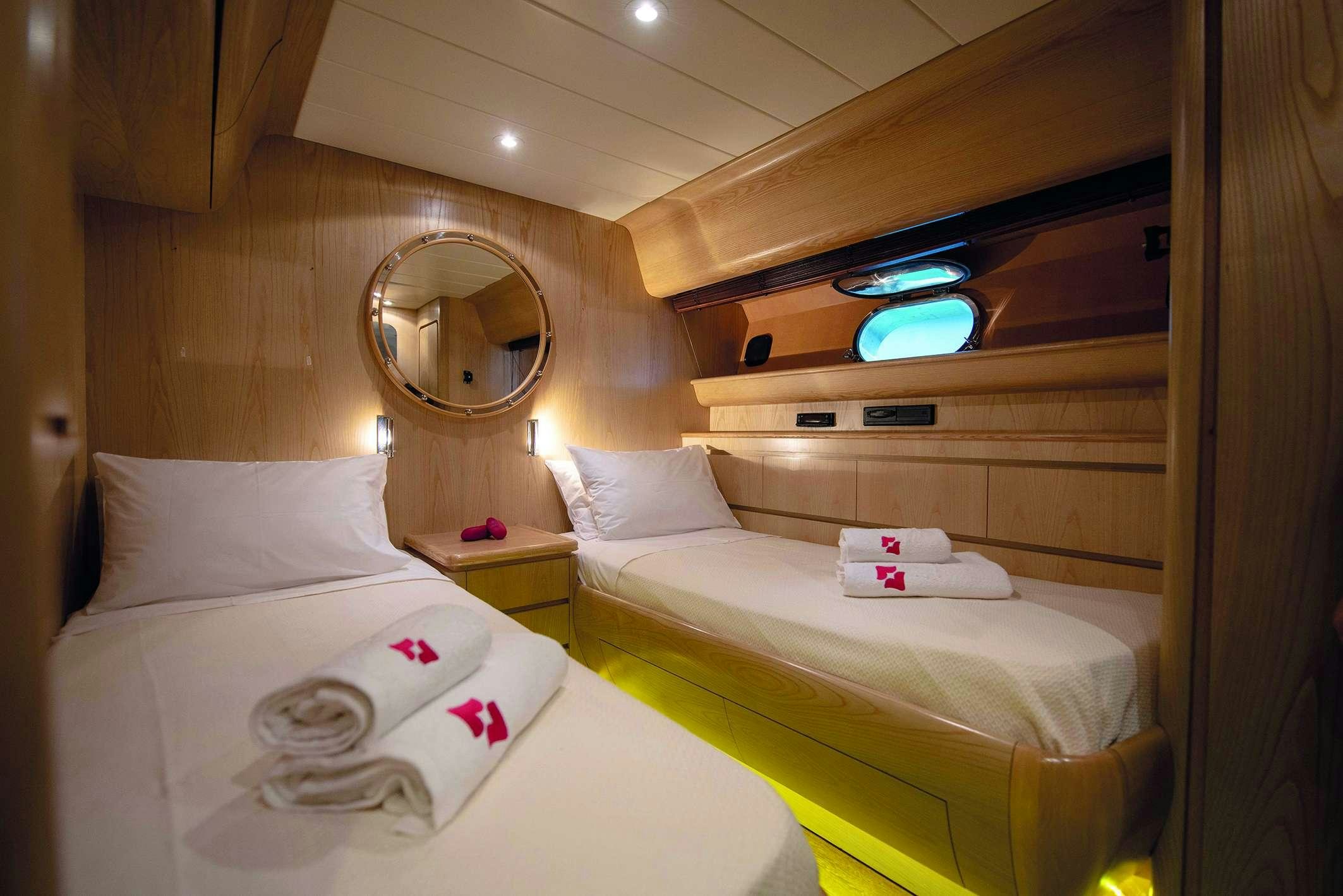a room with two beds aboard KISS Yacht for Charter