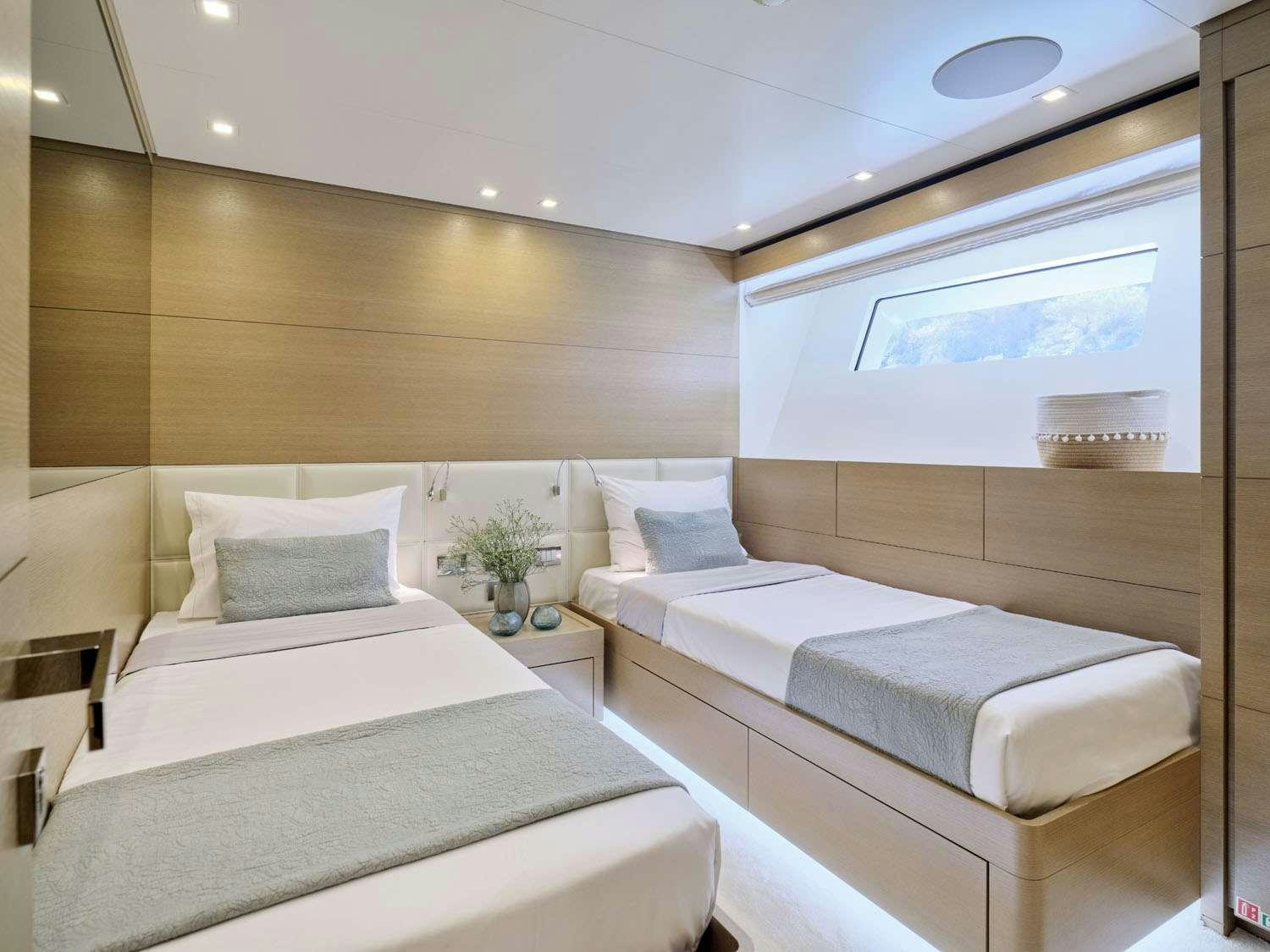 a room with a couple of beds aboard FLOR Yacht for Charter