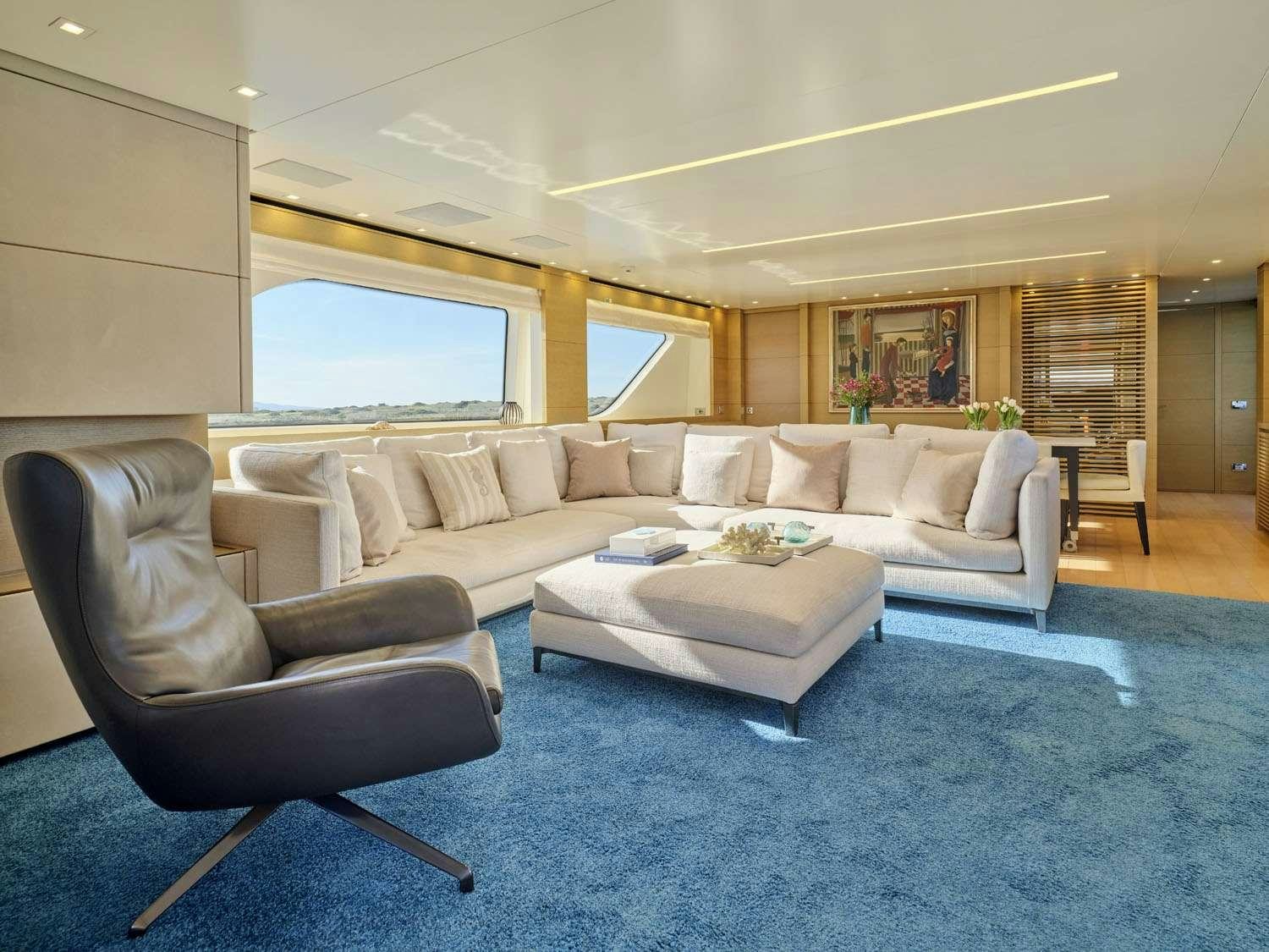 a living room with a couch and a table aboard FLOR Yacht for Charter