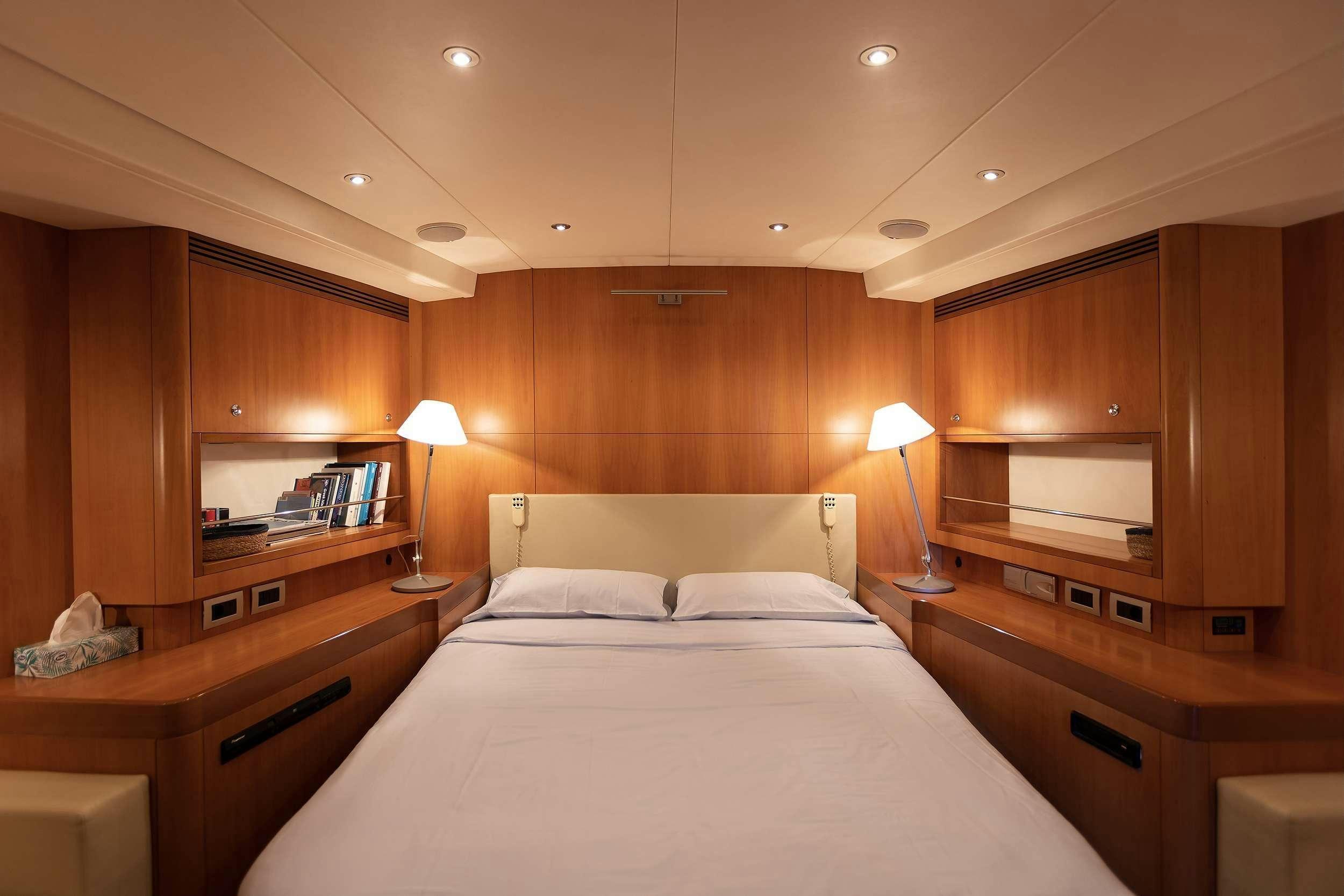 a bedroom with a bed and a desk aboard MELITI Yacht for Charter