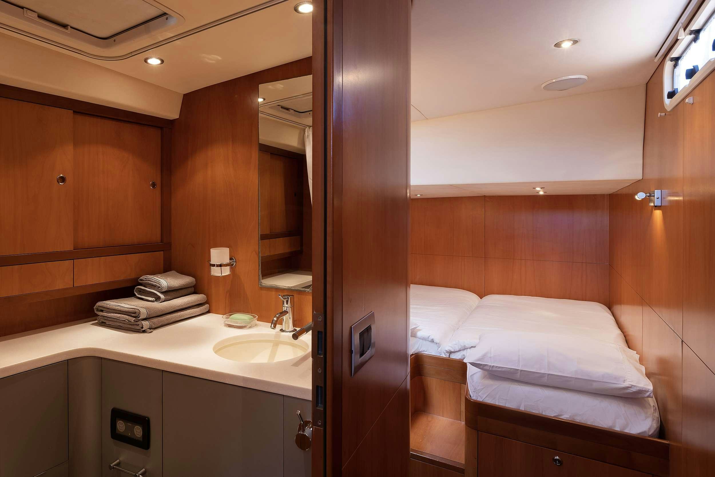 a bathroom with a bed and sink aboard MELITI Yacht for Charter