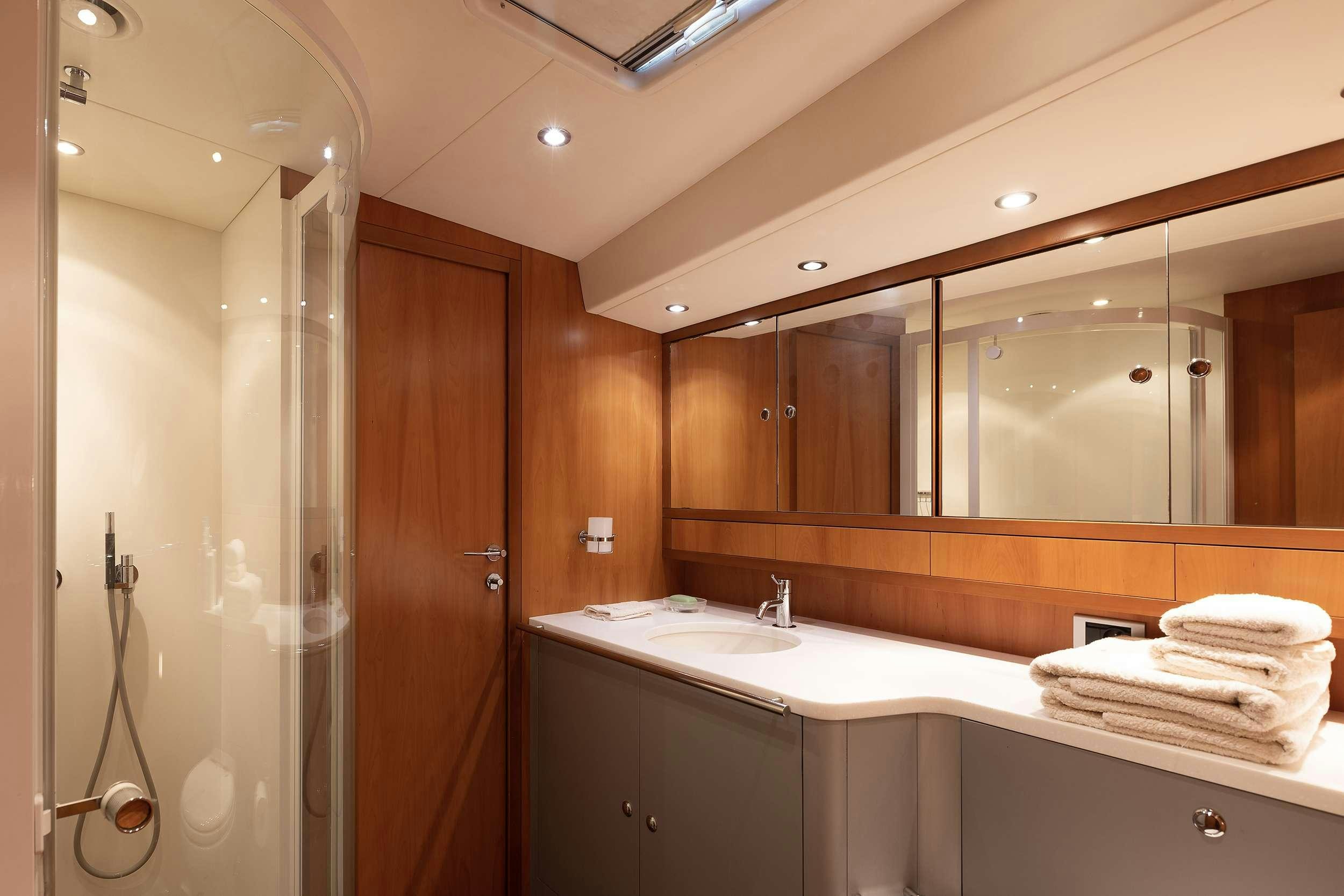 a bathroom with a shower and sink aboard MELITI Yacht for Charter