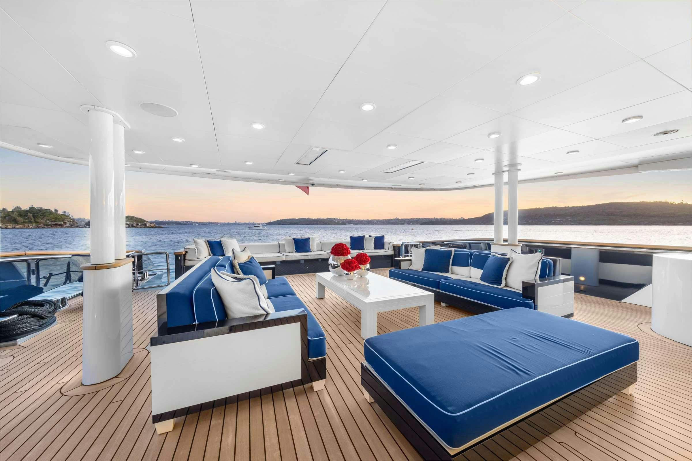 a boat with a table and chairs aboard MISCHIEF 1 Yacht for Charter
