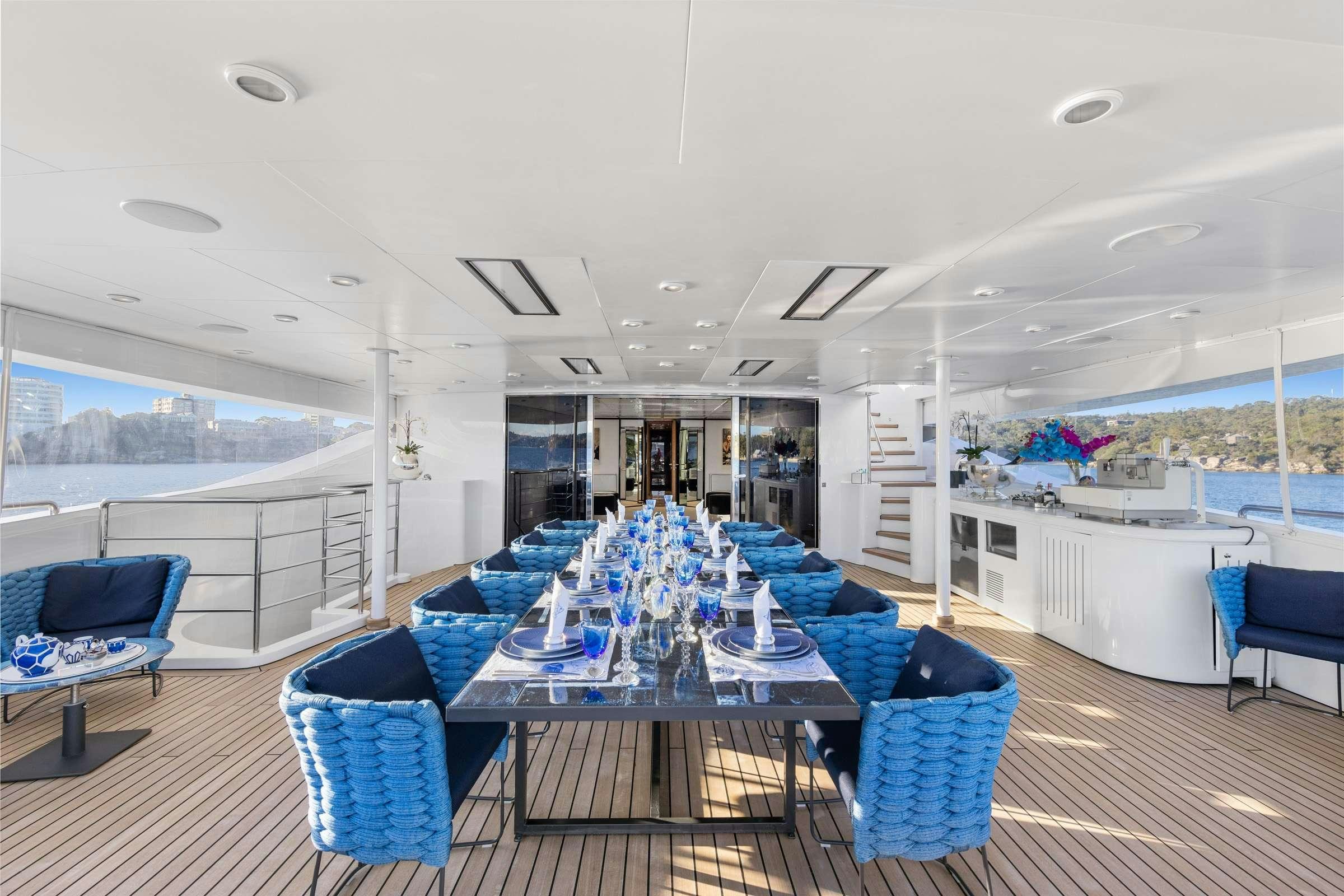 a large room with a table and chairs aboard MISCHIEF 1 Yacht for Charter