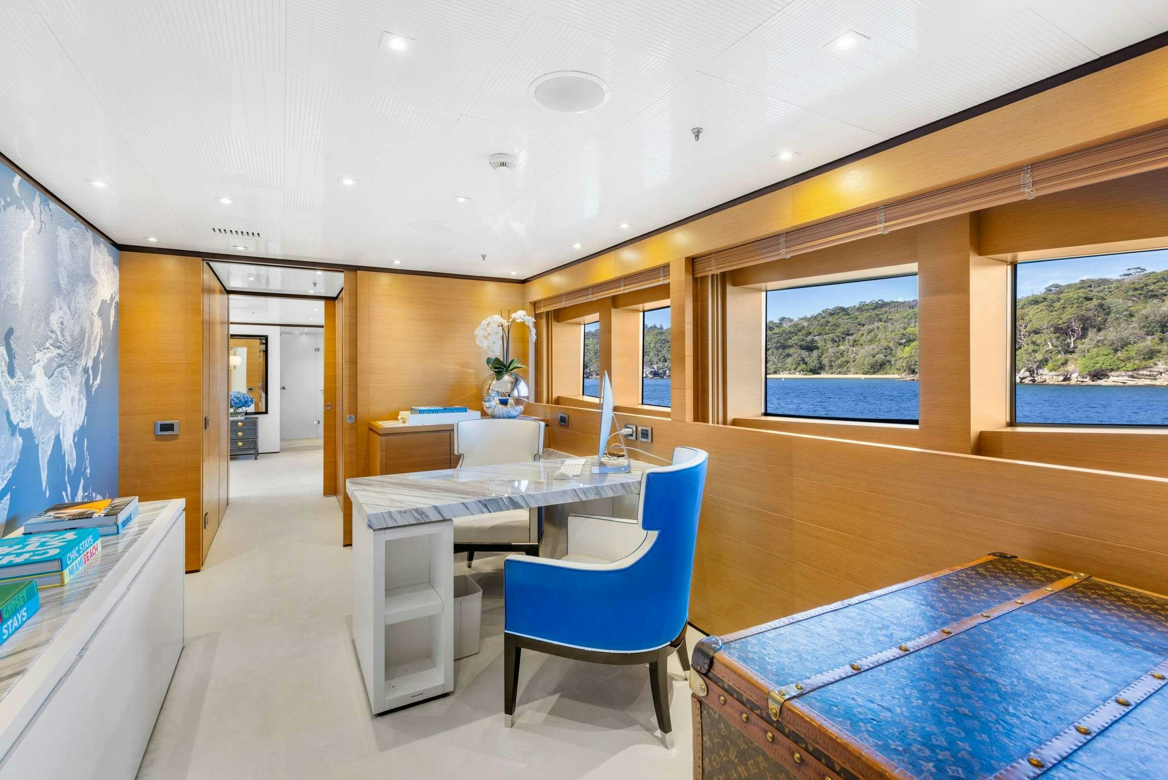 a room with a table and chairs aboard MISCHIEF 1 Yacht for Charter