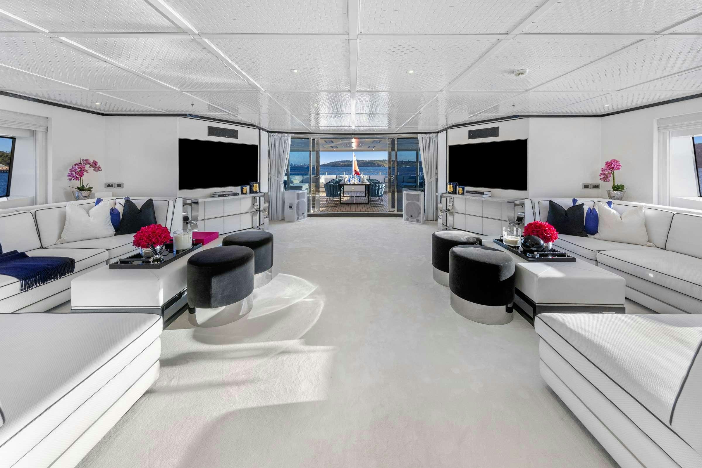 a room with white furniture aboard MISCHIEF 1 Yacht for Charter