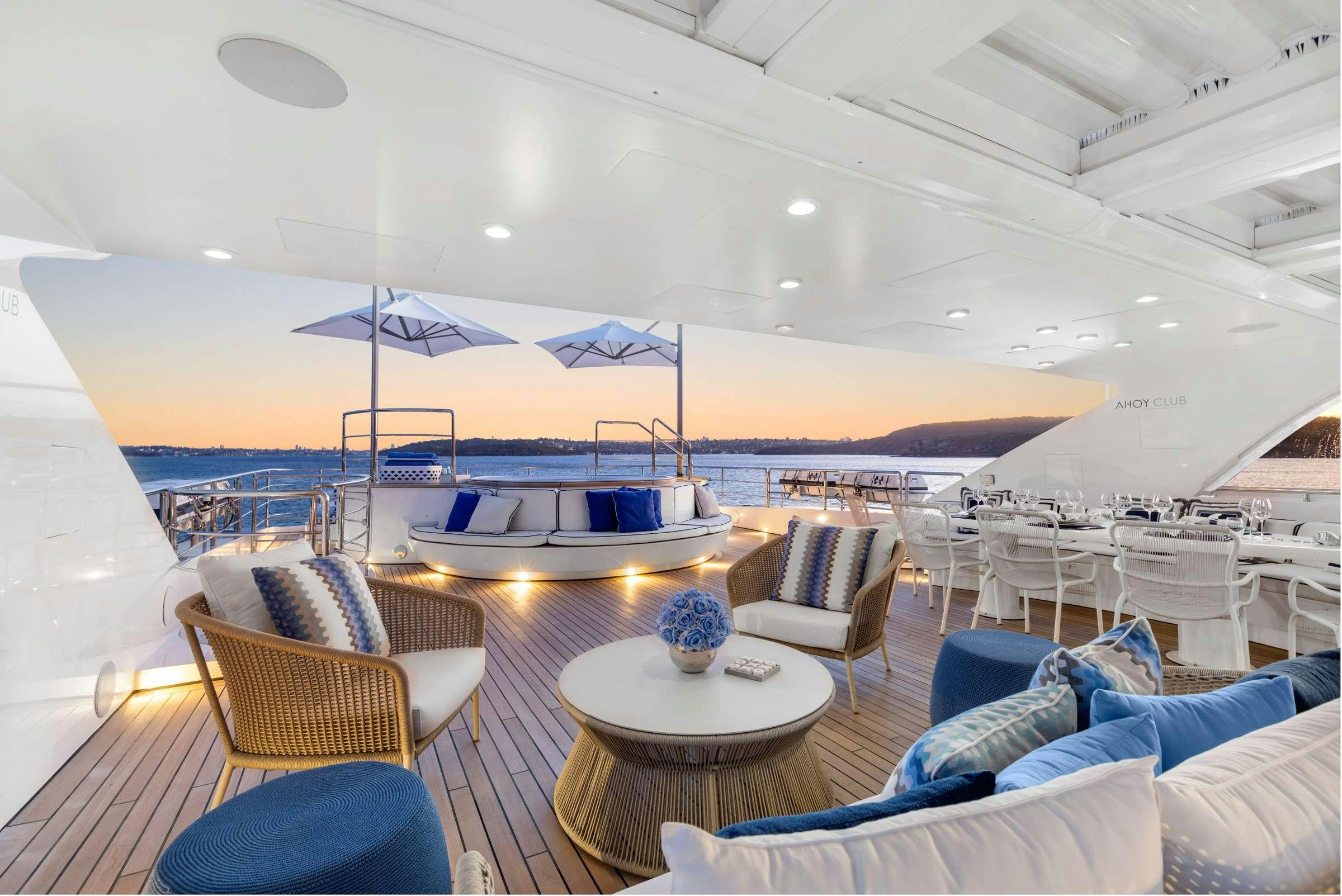 a large lounge area with a large swimming pool and a large boat aboard MISCHIEF 1 Yacht for Charter