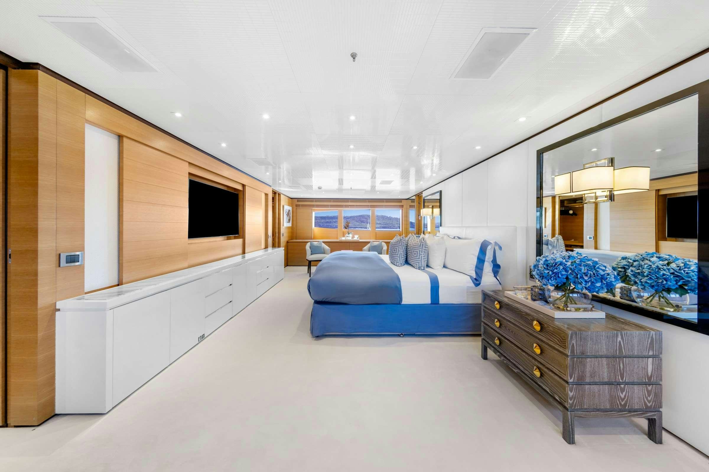 a large room with a bed and desk aboard MISCHIEF 1 Yacht for Charter