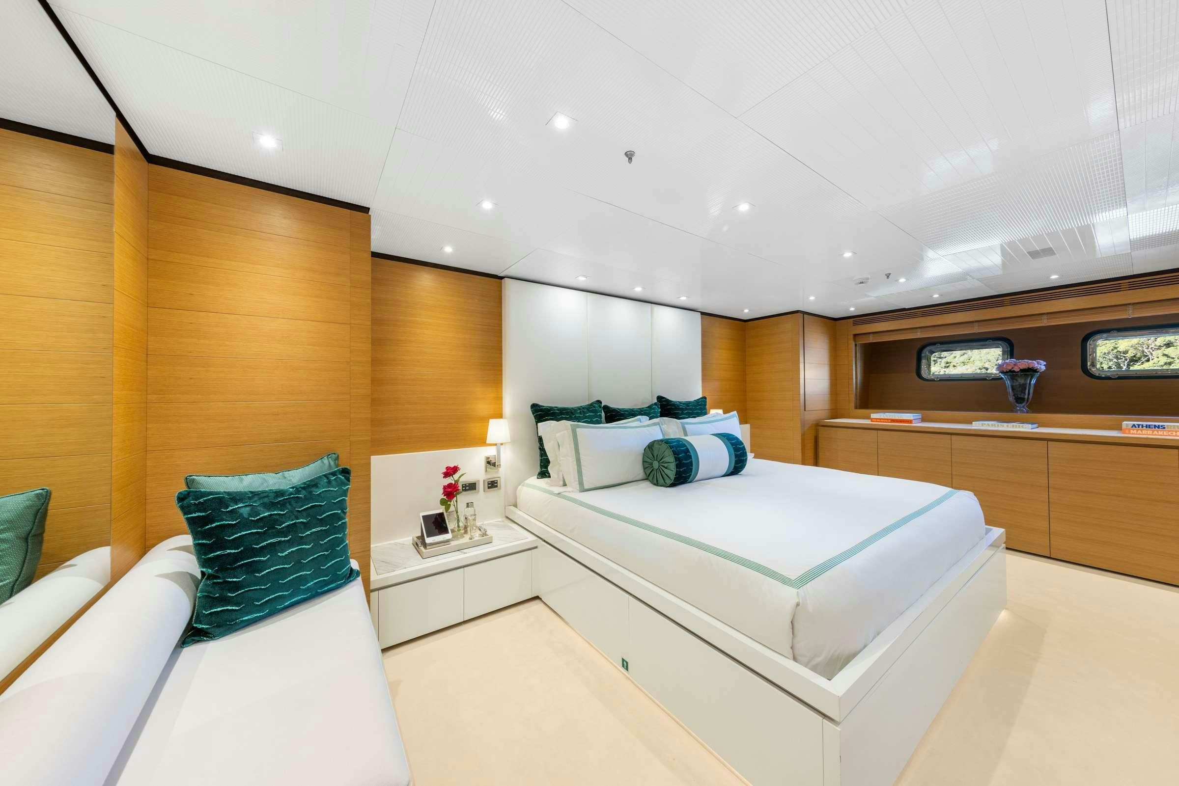 a room with a bed and a shelf with a mirror aboard MISCHIEF 1 Yacht for Charter
