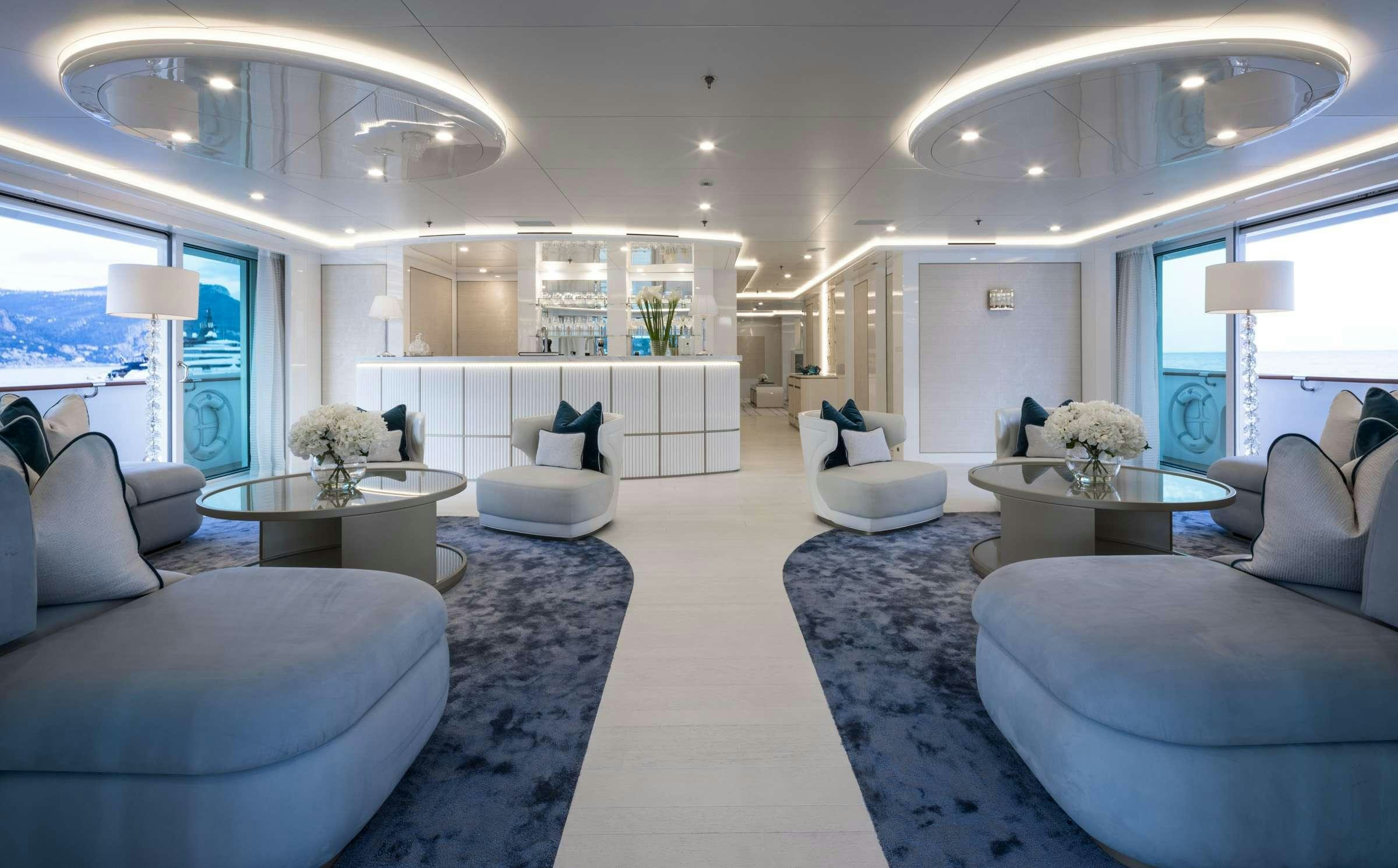 a living room with white furniture aboard CORAL OCEAN Yacht for Charter