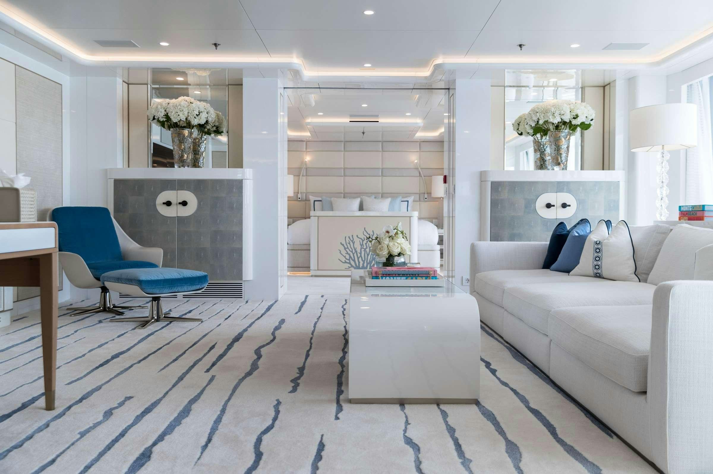 a living room with a blue chair aboard CORAL OCEAN Yacht for Charter