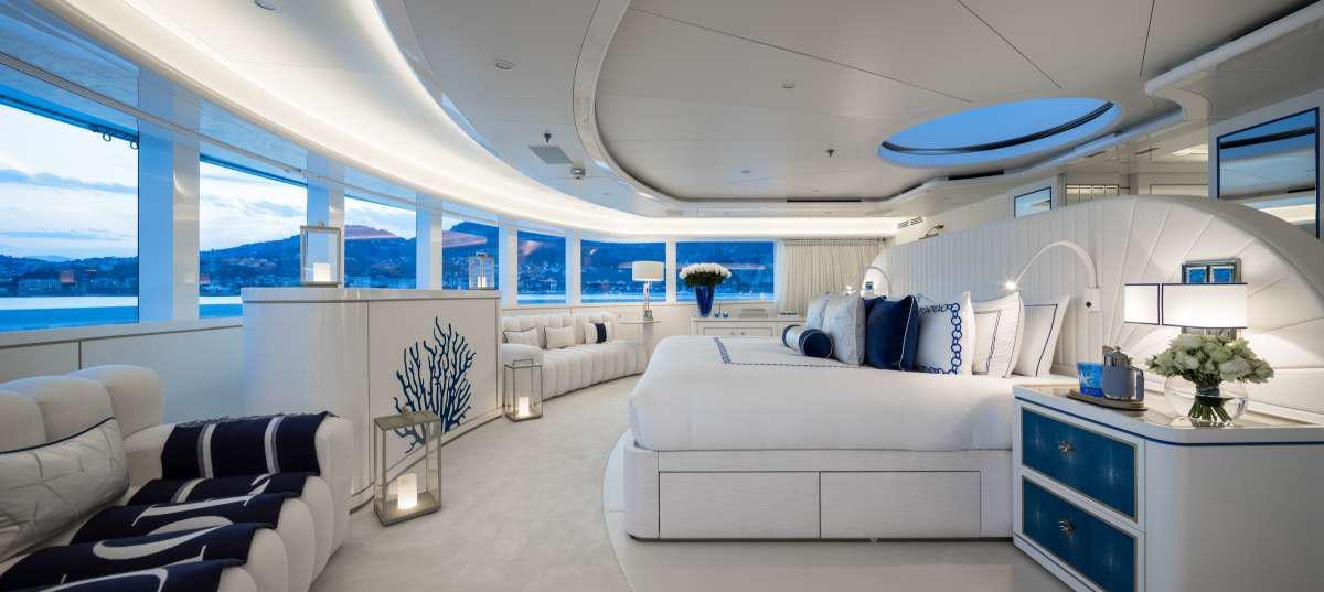 a room with a bed and a desk aboard CORAL OCEAN Yacht for Charter