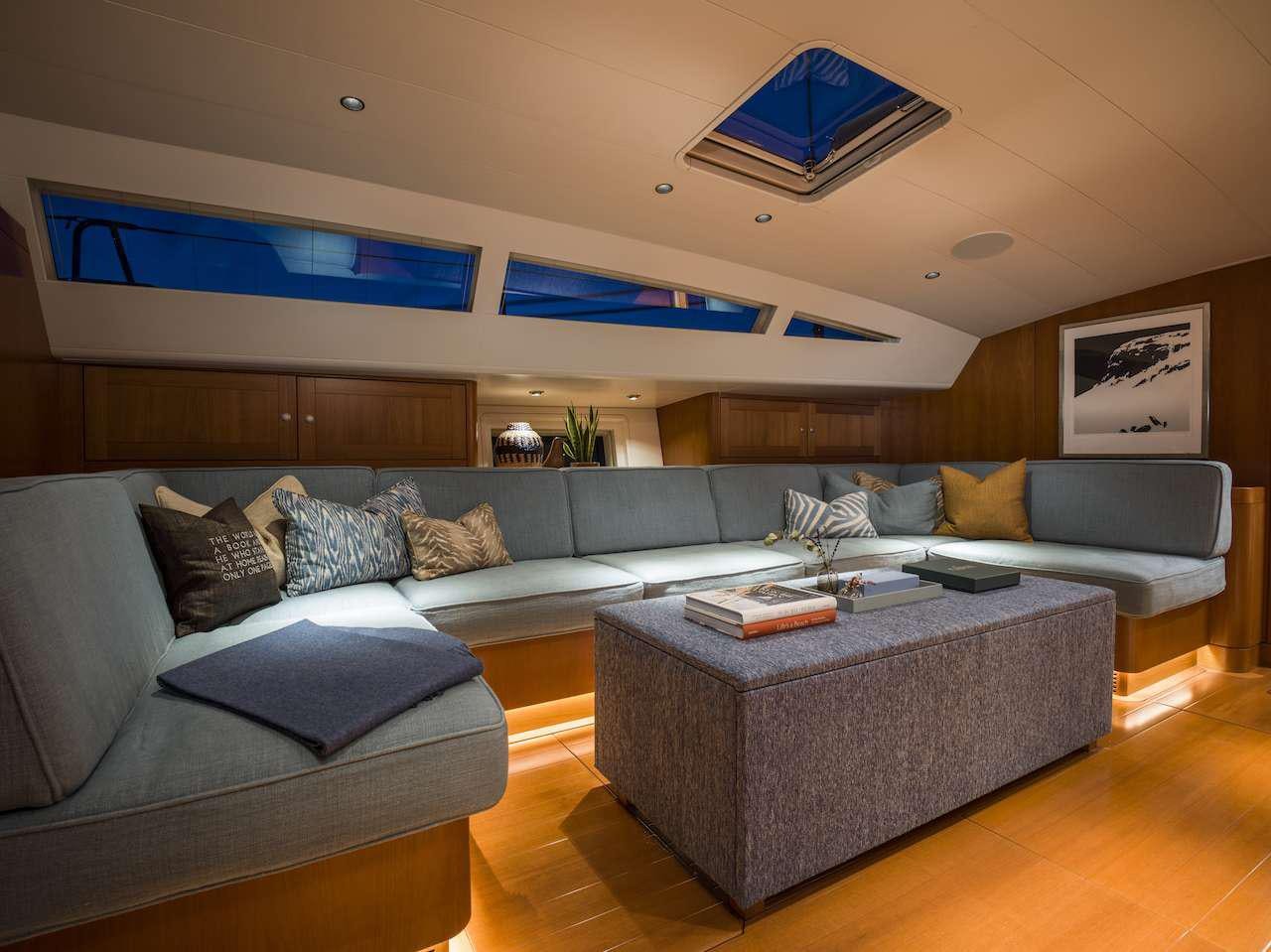 a living room with a couch and a tv aboard ONYX Yacht for Charter