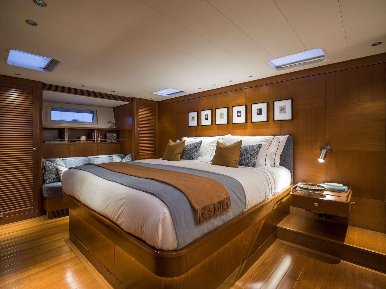 a room with a bed and a desk aboard ONYX Yacht for Charter