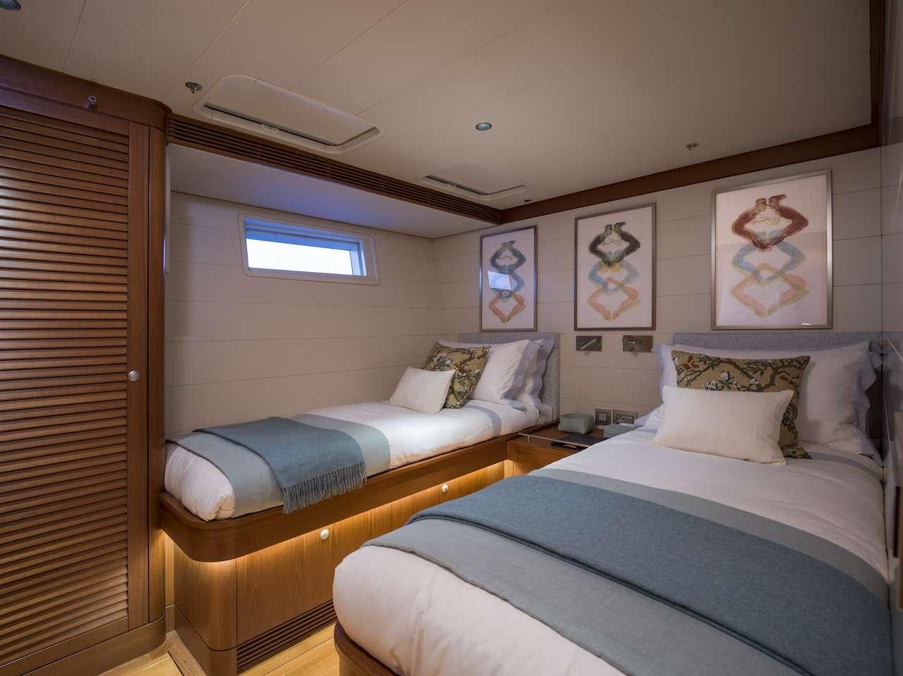 a couple of beds in a room aboard ONYX Yacht for Charter