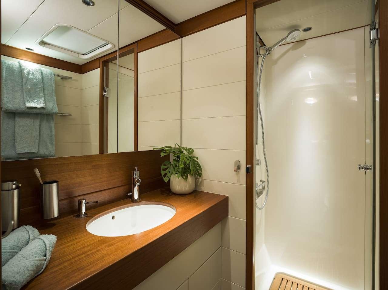 a bathroom with a shower and sink aboard ONYX Yacht for Charter