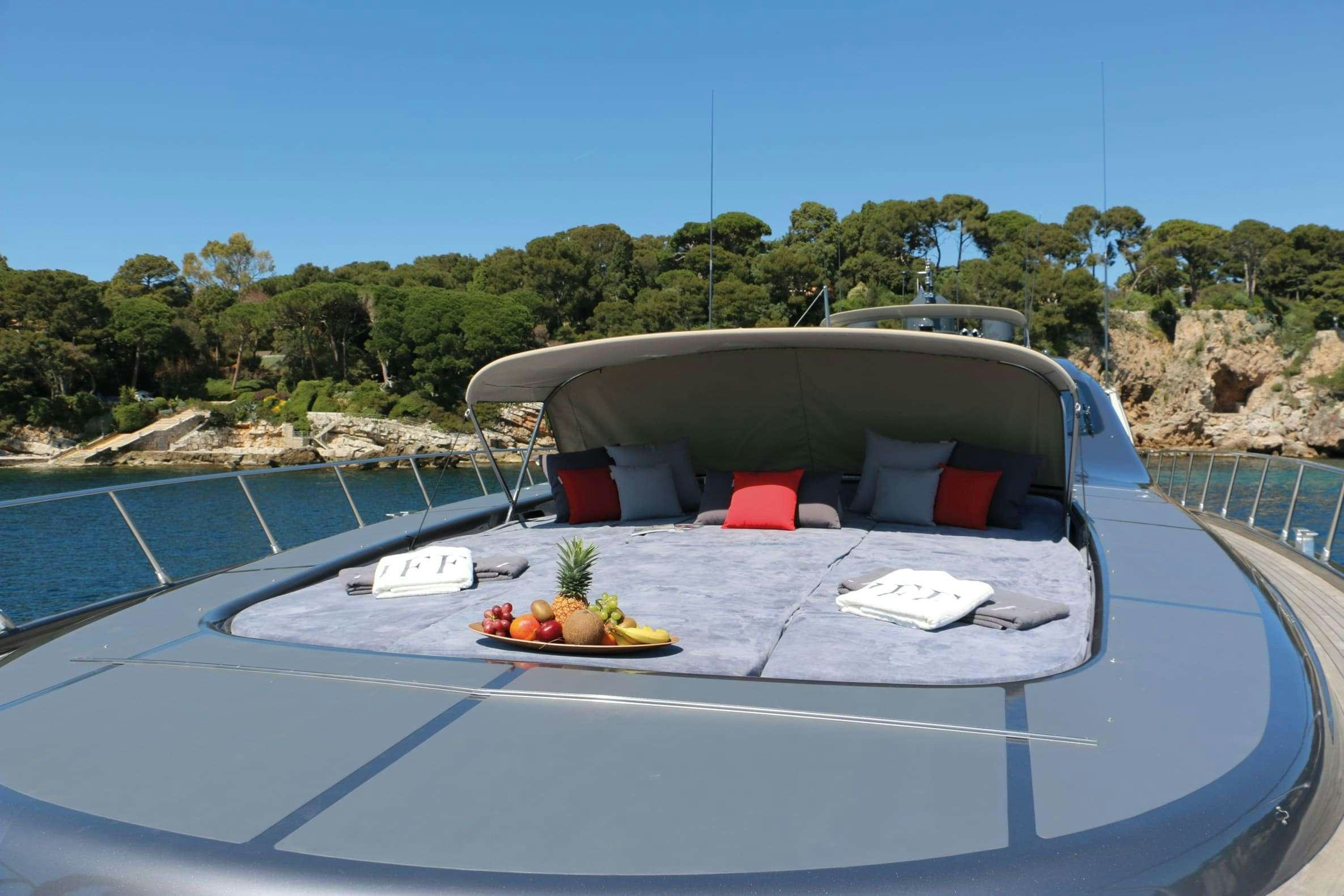 a pool with a table and chairs aboard JFF Yacht for Charter