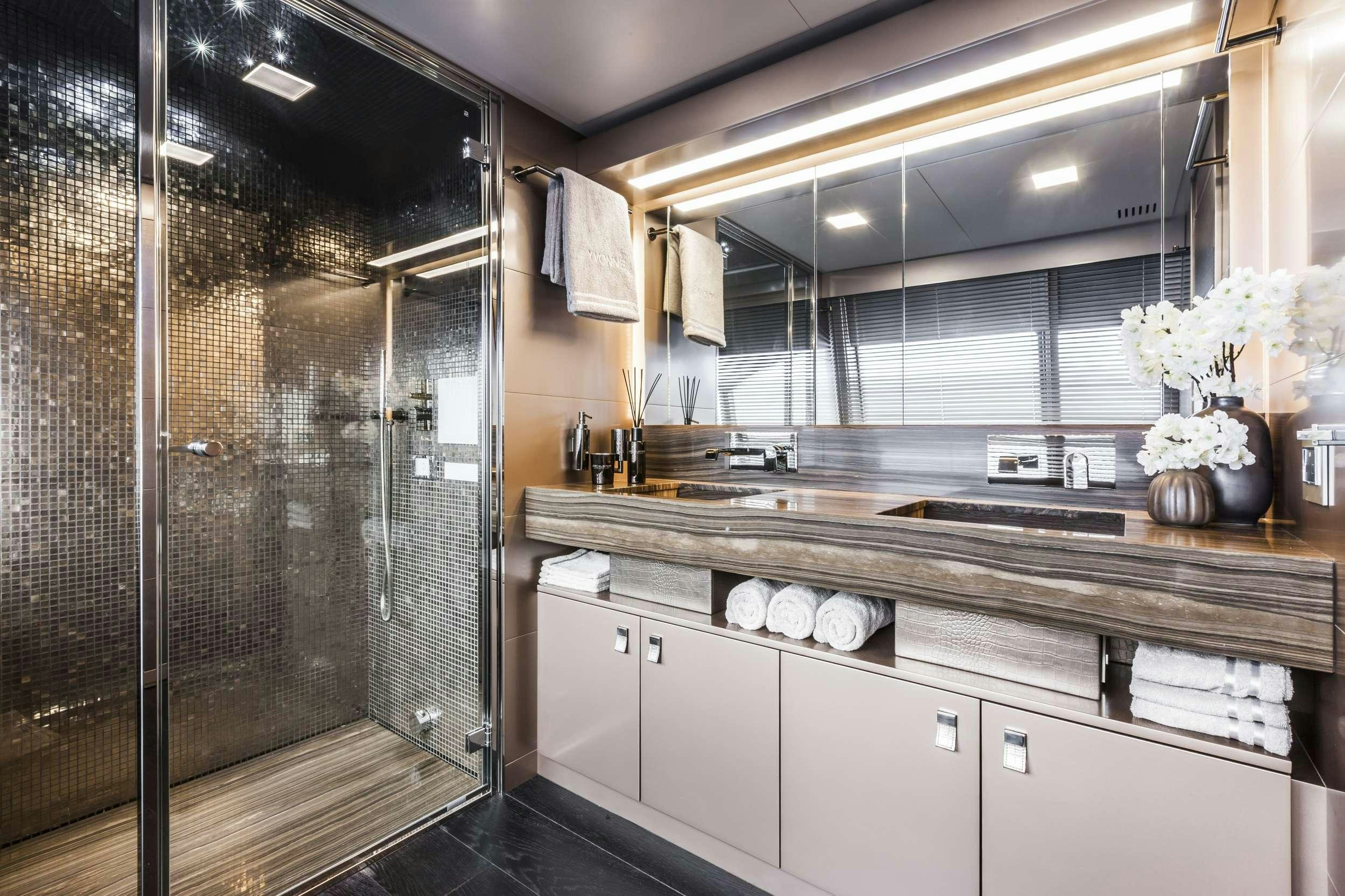 a bathroom with a glass shower aboard YVONNE Yacht for Charter