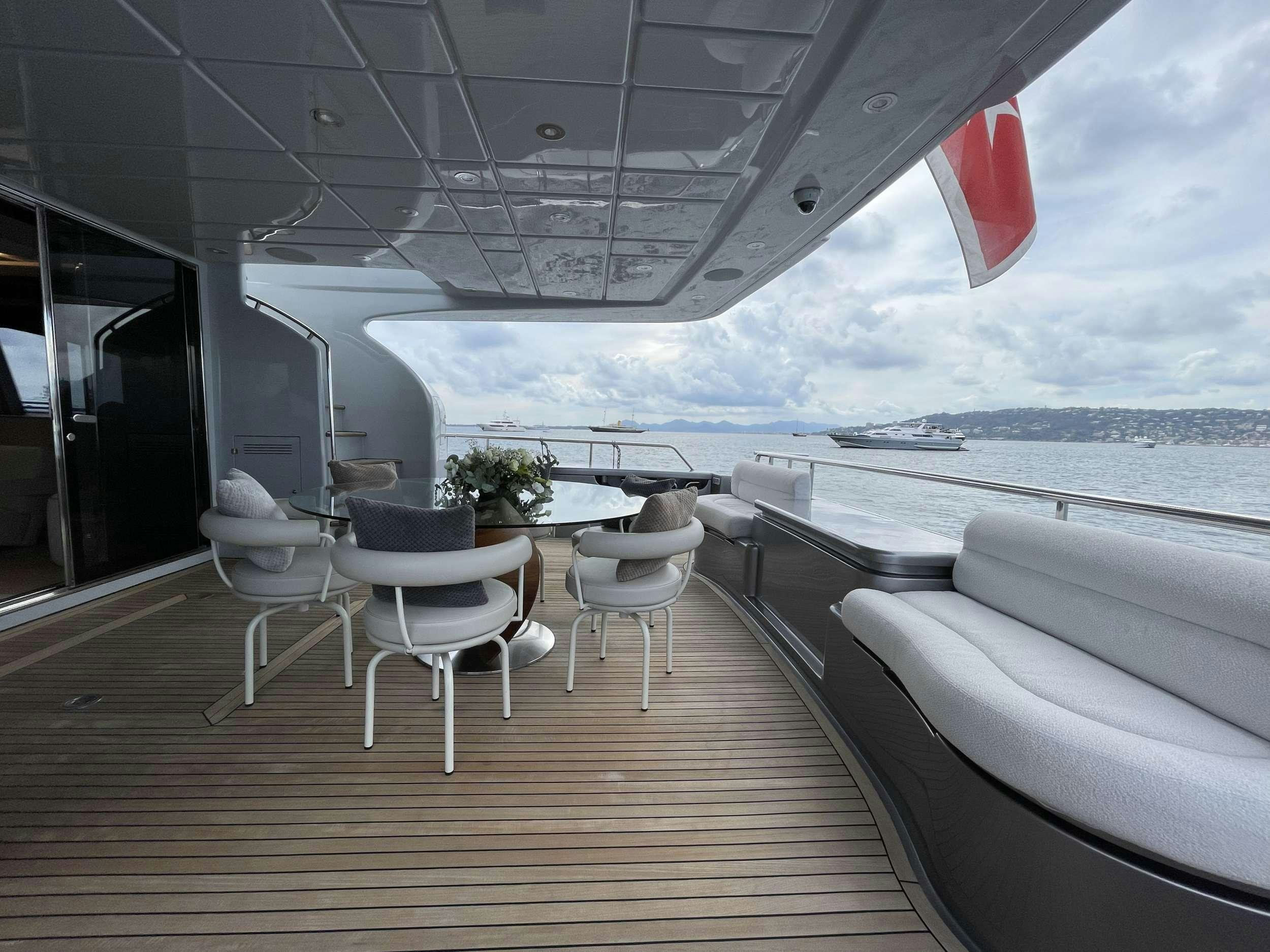 a deck with chairs and tables aboard FERRETTI 881 RPH Yacht for Charter