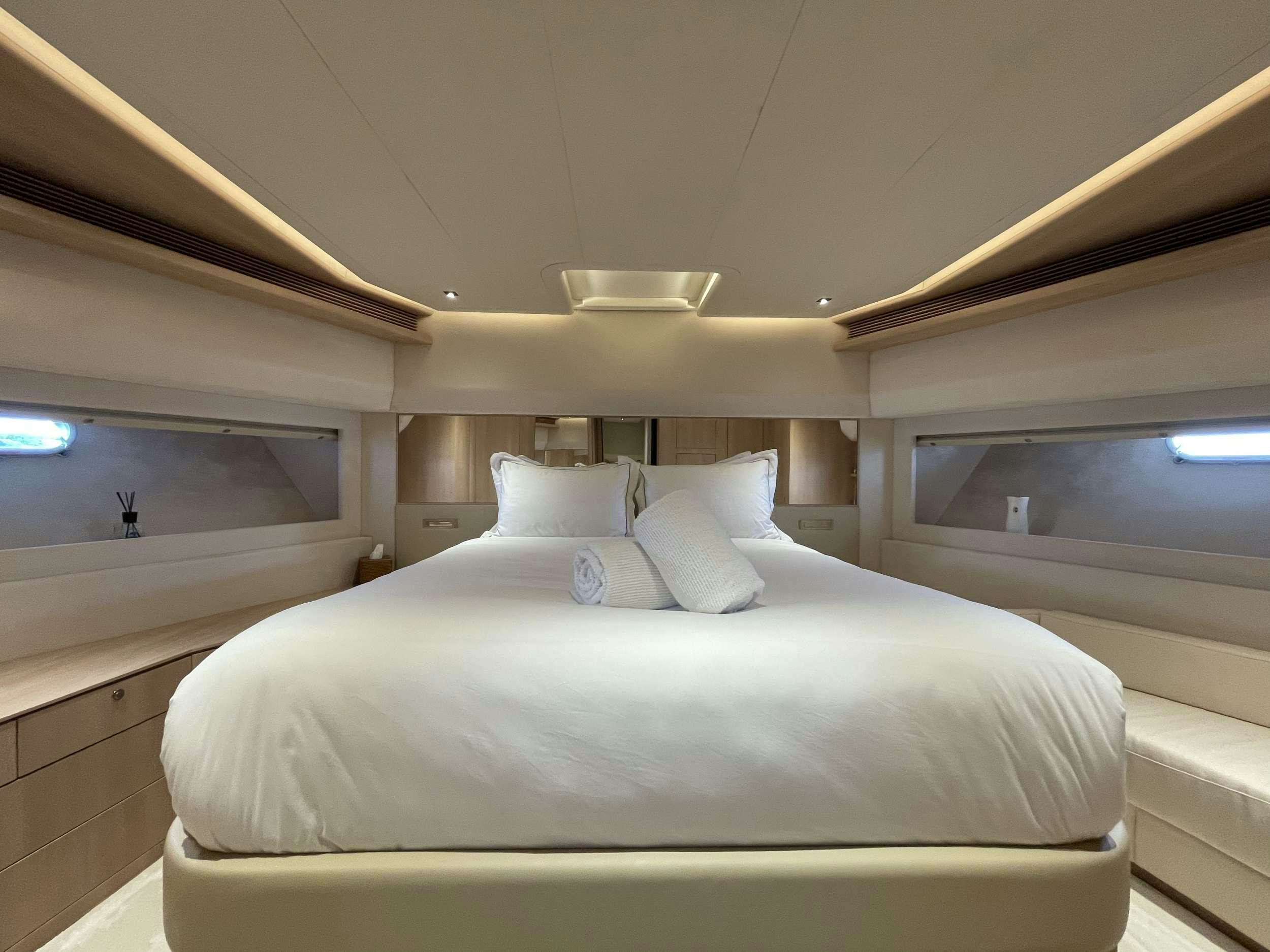 a bed in a room aboard FERRETTI 881 RPH Yacht for Charter