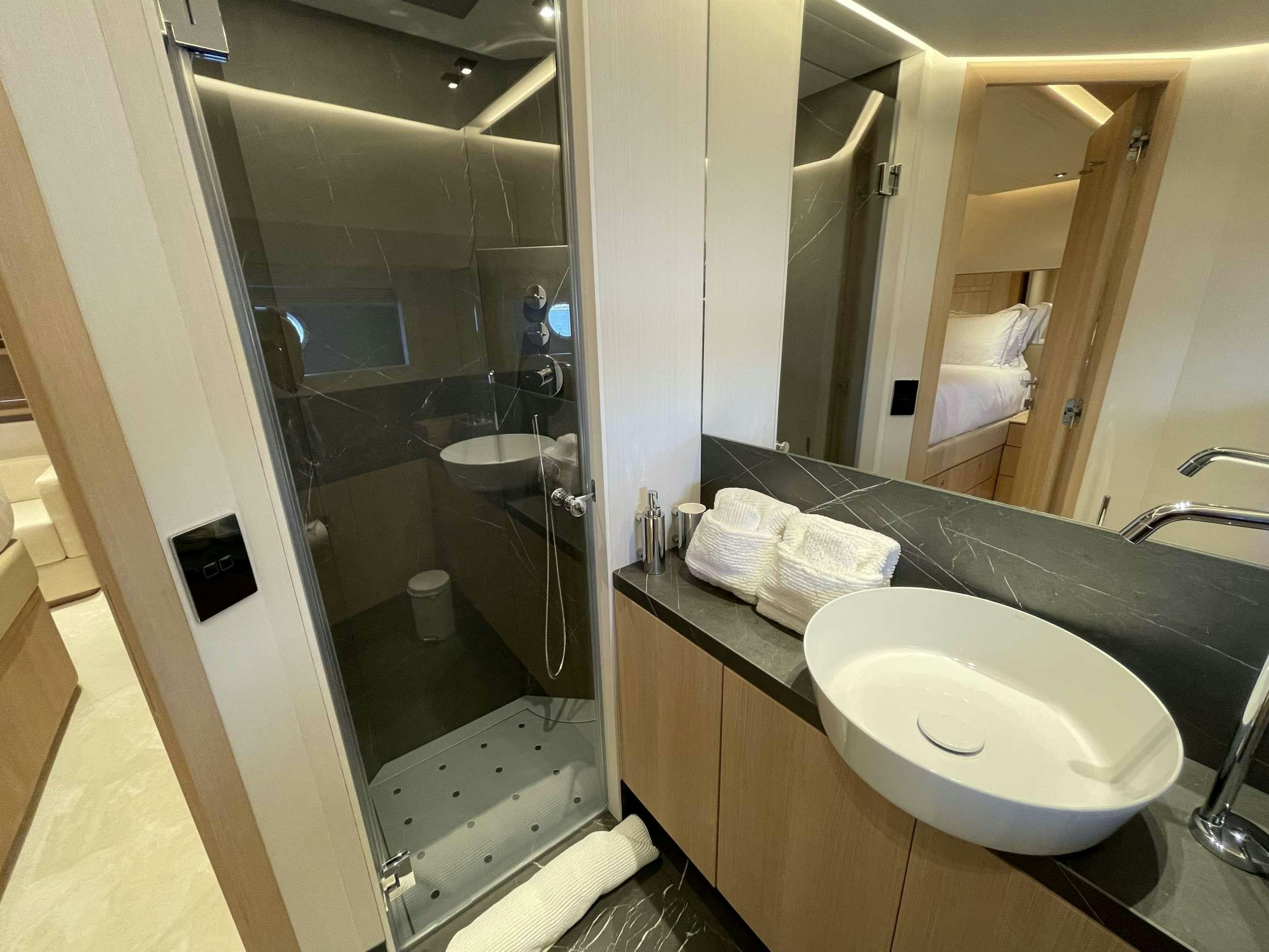a bathroom with a sink and a mirror aboard FERRETTI 881 RPH Yacht for Charter