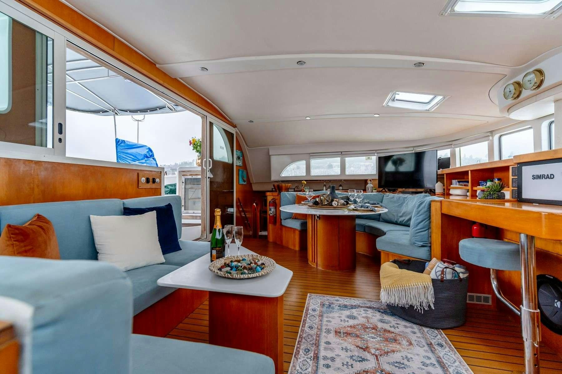 a room with a couch and a table aboard TABULA RASA Yacht for Charter