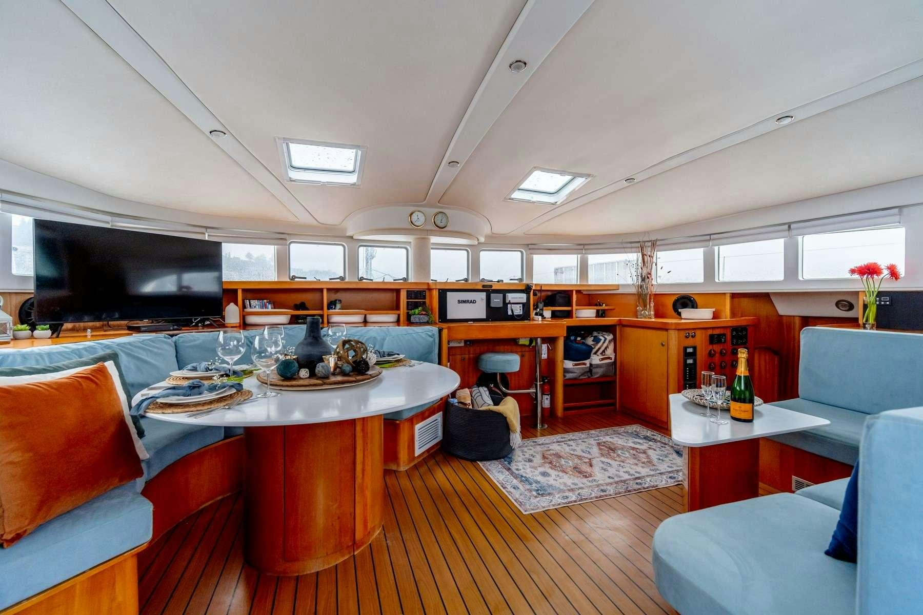 a room with a table and chairs aboard TABULA RASA Yacht for Charter