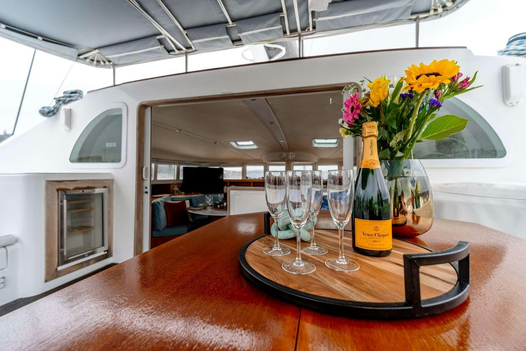 a table with glasses and flowers aboard TABULA RASA Yacht for Charter