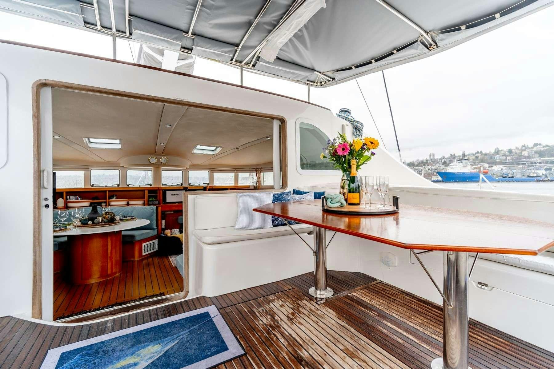 a room with a table and chairs aboard TABULA RASA Yacht for Charter