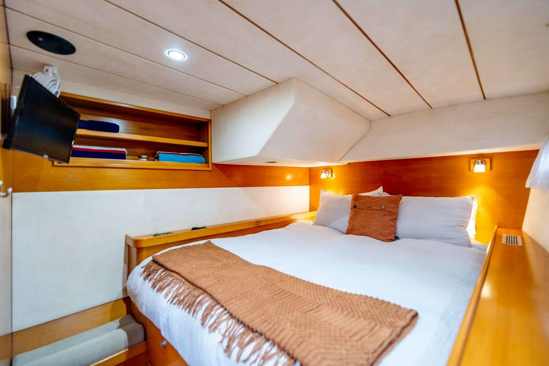 a bed with a television on the ceiling aboard TABULA RASA Yacht for Charter