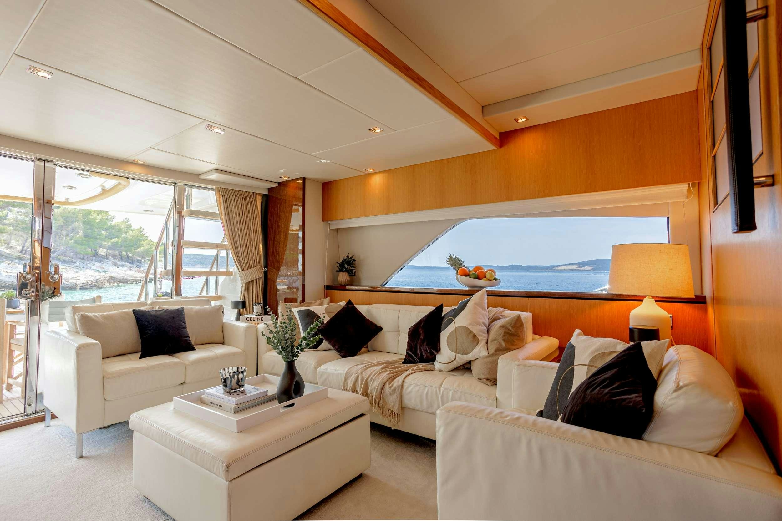 a living room with a large window aboard JOLIDOR Yacht for Charter