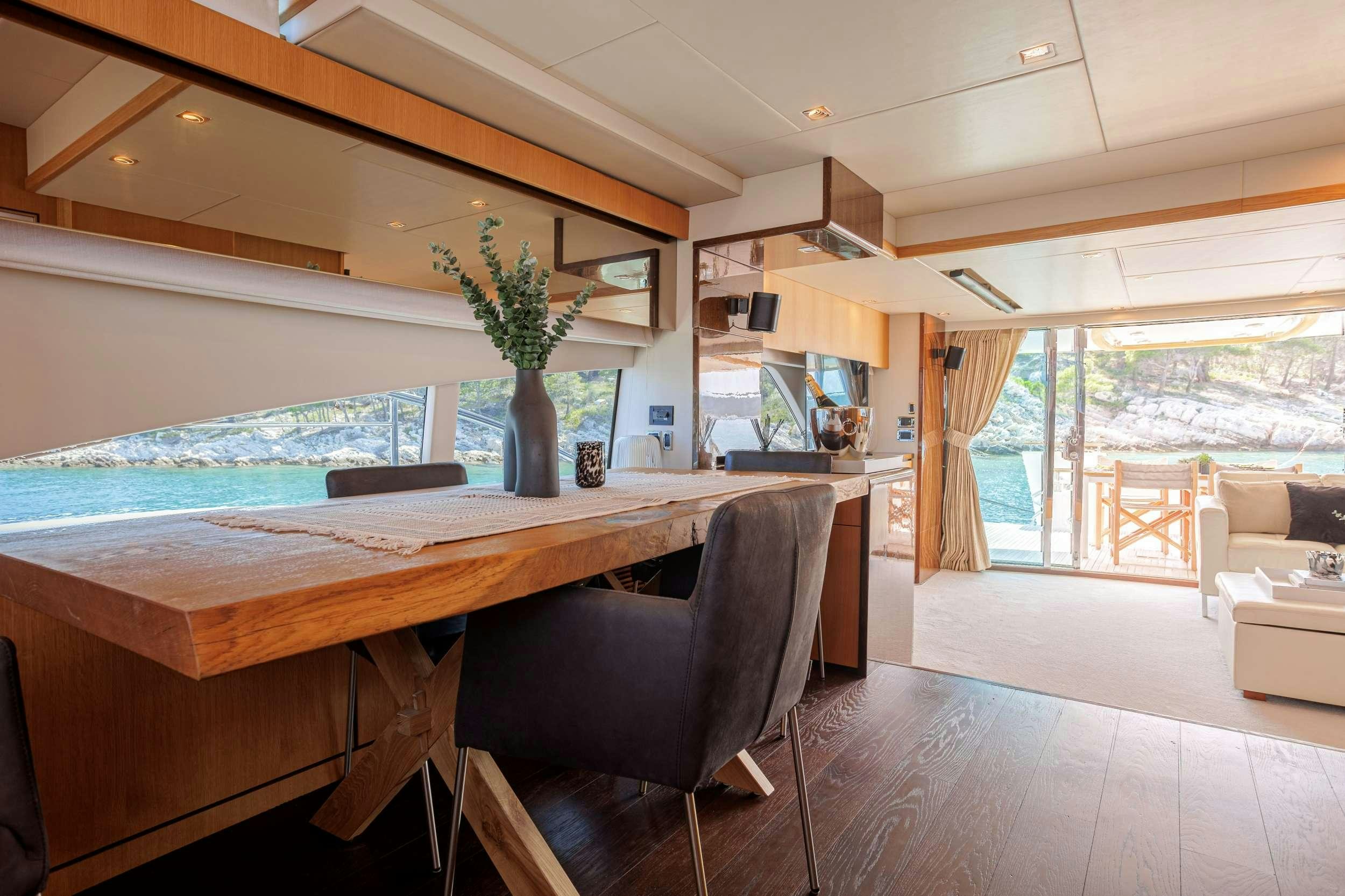 a room with a table and chairs aboard JOLIDOR Yacht for Charter