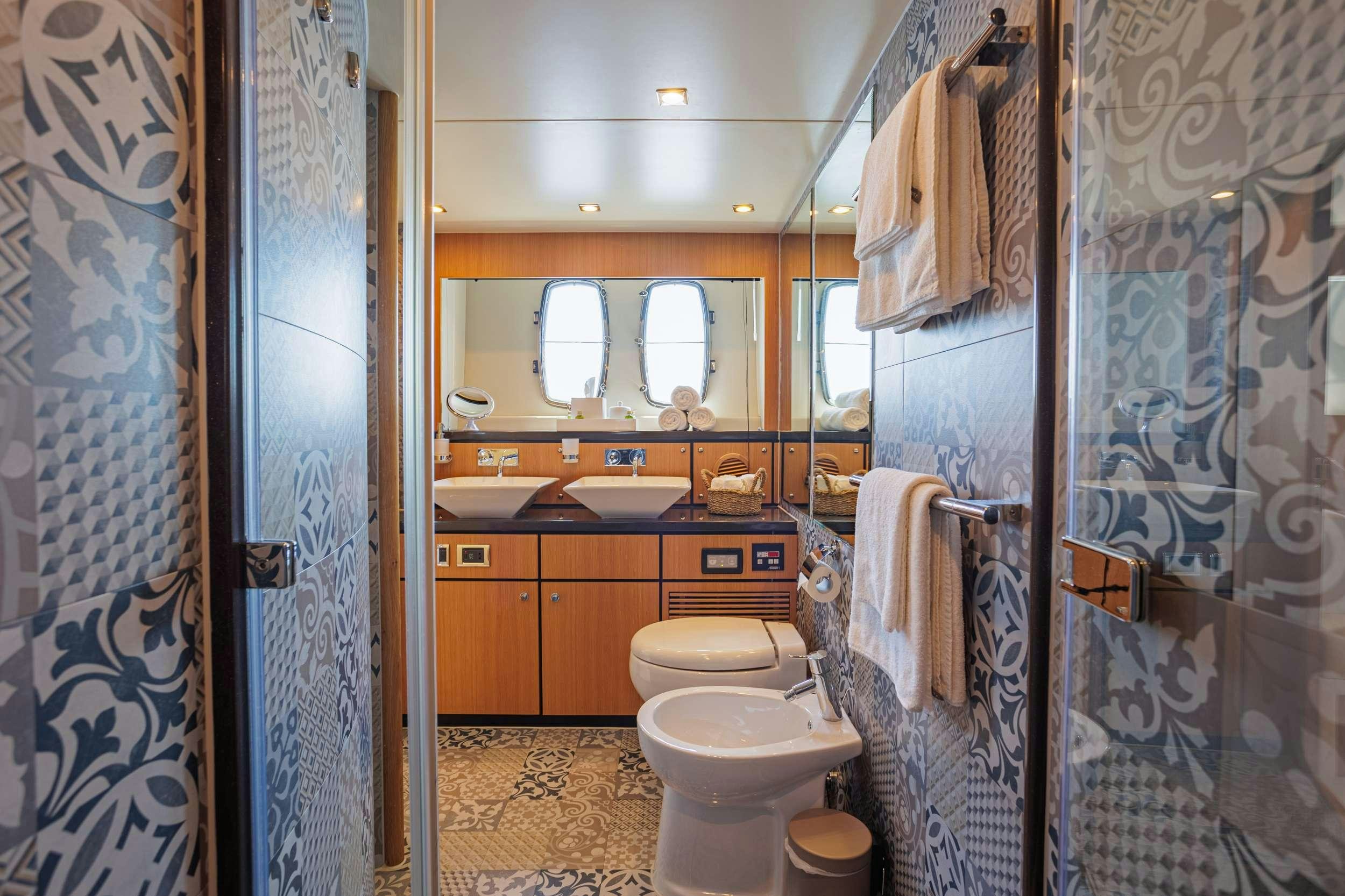 a bathroom with a toilet and sink aboard JOLIDOR Yacht for Charter