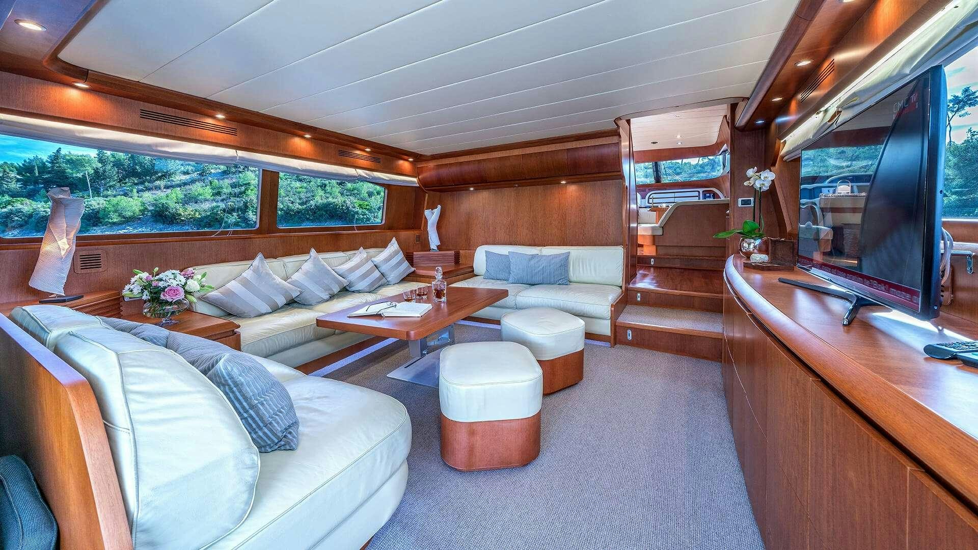 a living room with a couch and a table aboard JANTAR Yacht for Charter