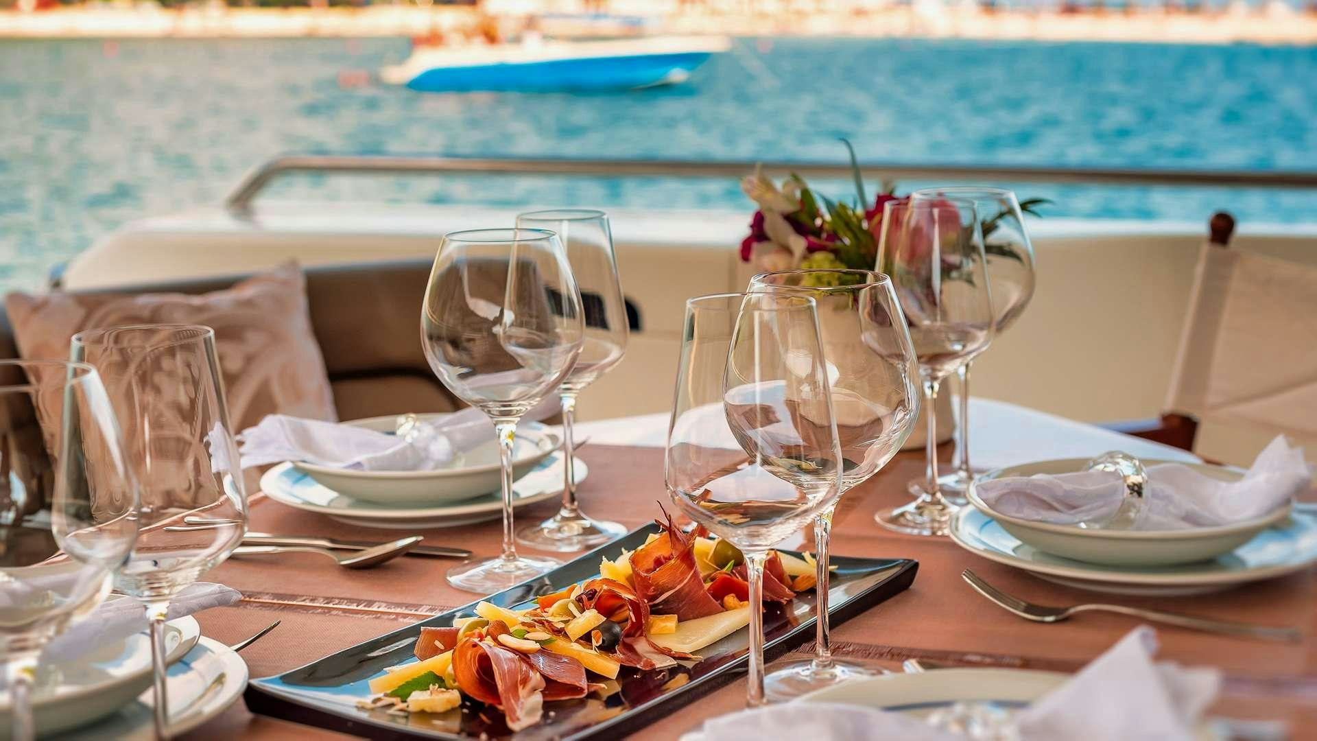a table set with glasses and food aboard M/Y MARINO Yacht for Charter