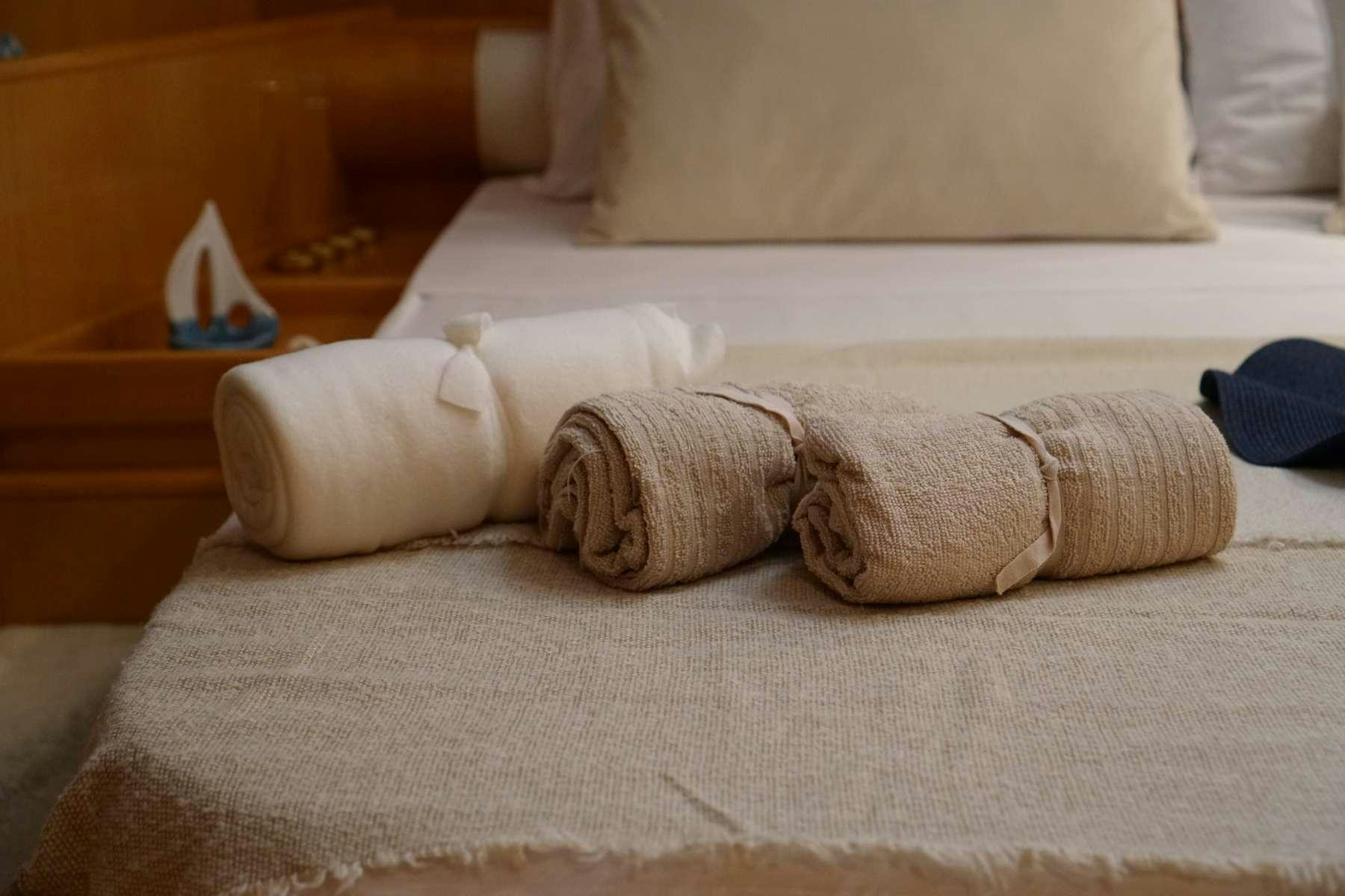 a pair of gloves on a bed aboard CIKILA Yacht for Charter