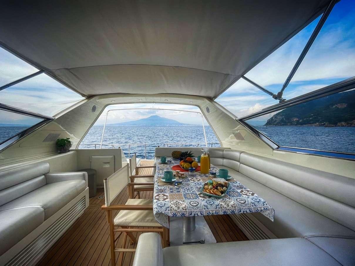 a boat with a table and chairs aboard CIKILA Yacht for Charter